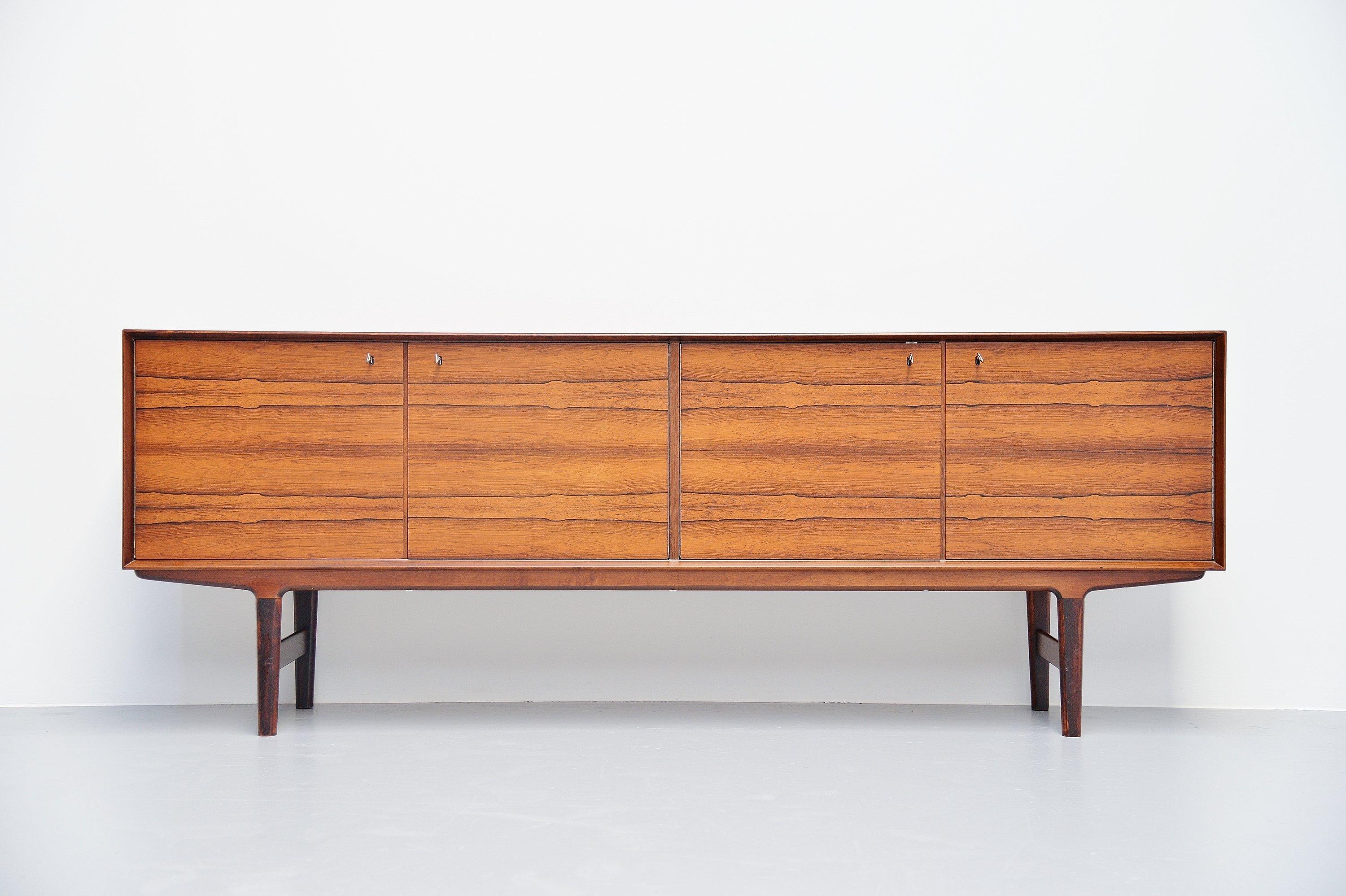 Stunning quality rosewood sideboard designed by Fredrik Kayser and manufactured by Viken, Norway, 1960. Rosewood construction with solid rosewood frame. Sideboard has four folding doors, with shelves and drawers on the inside. This excellent piece