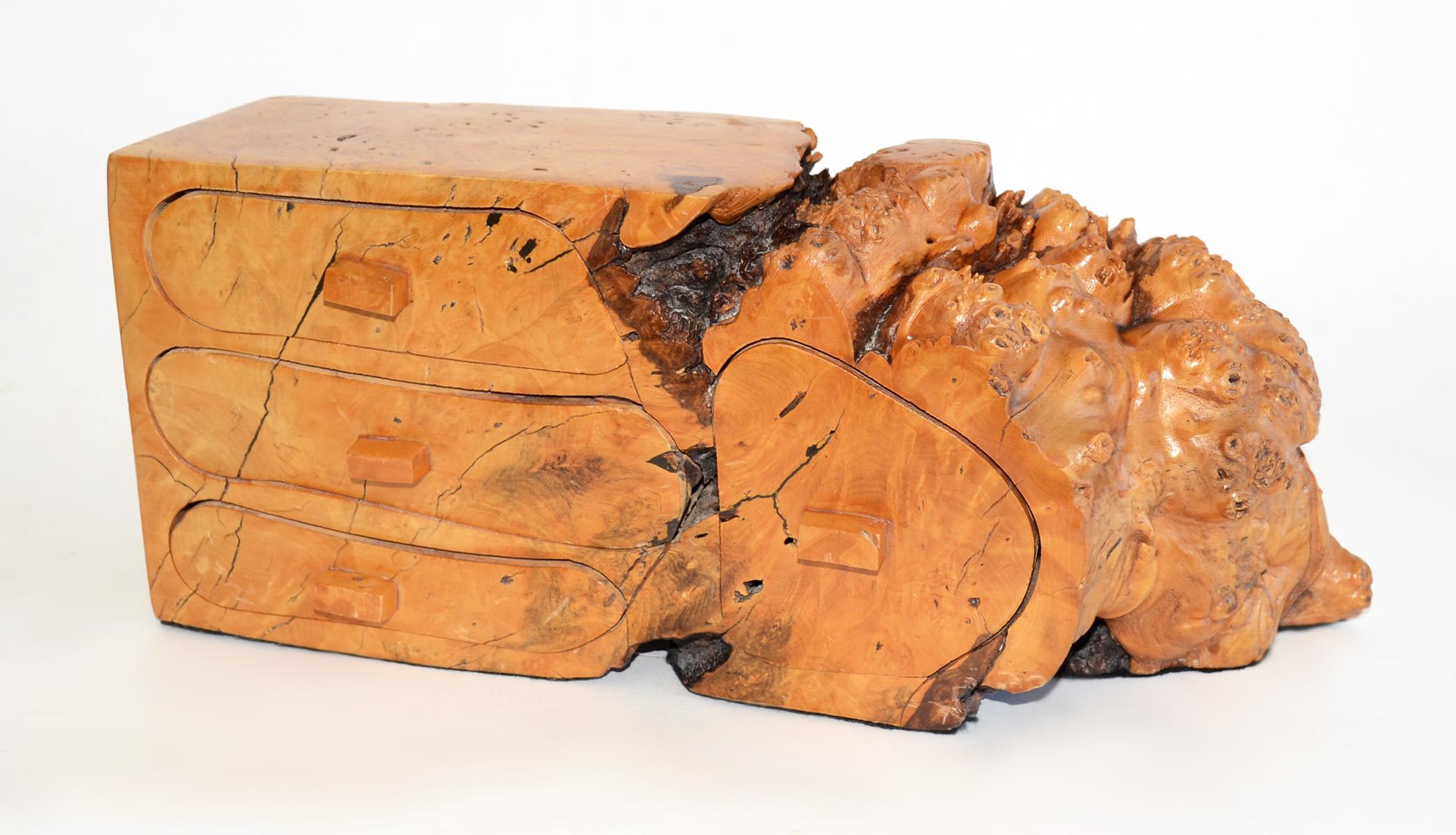 Free Edge Burl Wood Jewelry Box Manner of Michael Elkans 1970's, USA
Hand-worked, found free-edge burl wood chunk with four drawers. Felt covers bottom, but likely a Michael Elkans creation. Rustic carved pulls and drawer dividers. 
Natural splits