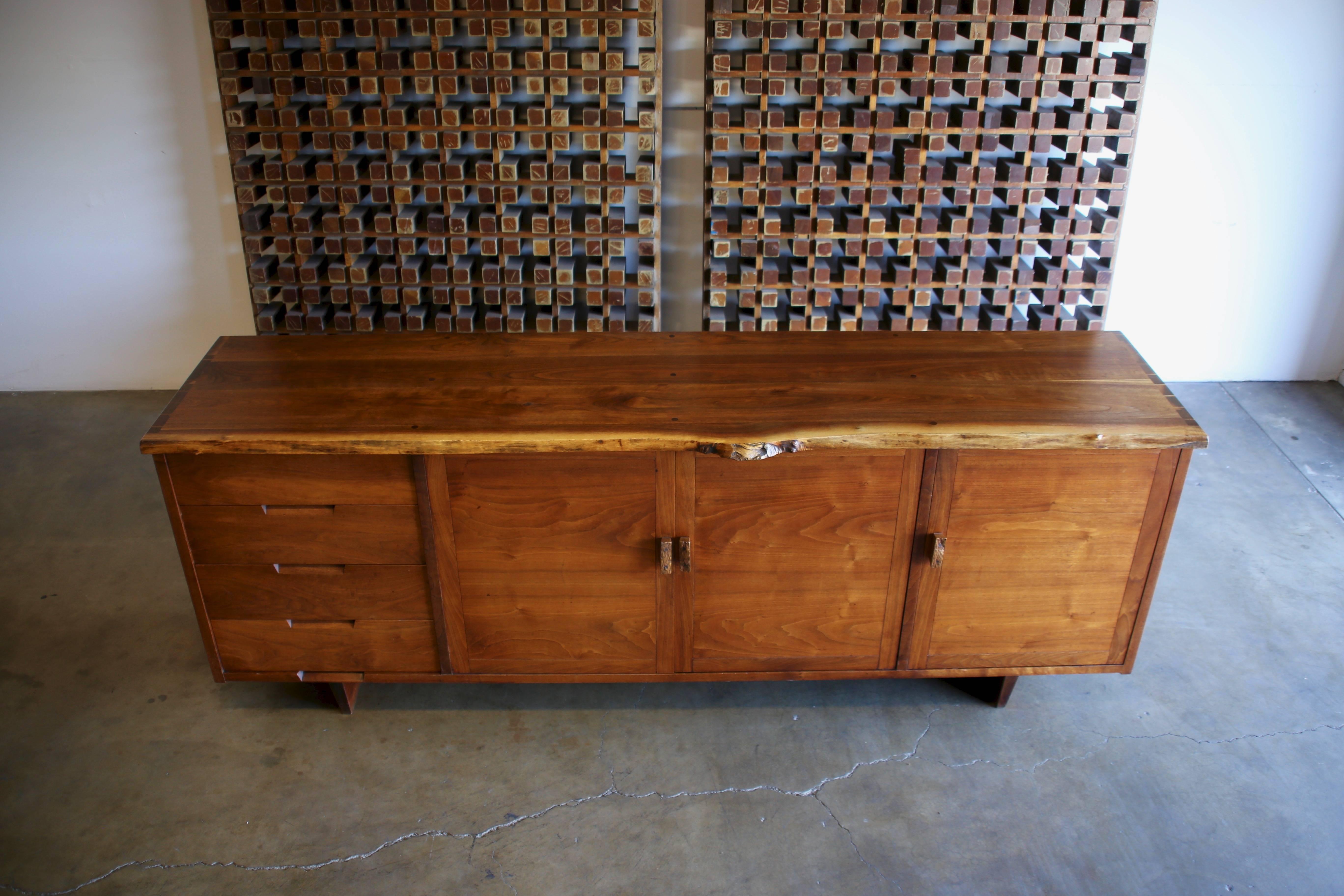 Studio crafted custom credenza by Gino Russo 1968. Gino Russo former craftsman for George Nakashima Studio. Beautiful solid walnut with exposed joinery and walnut burl pulls.