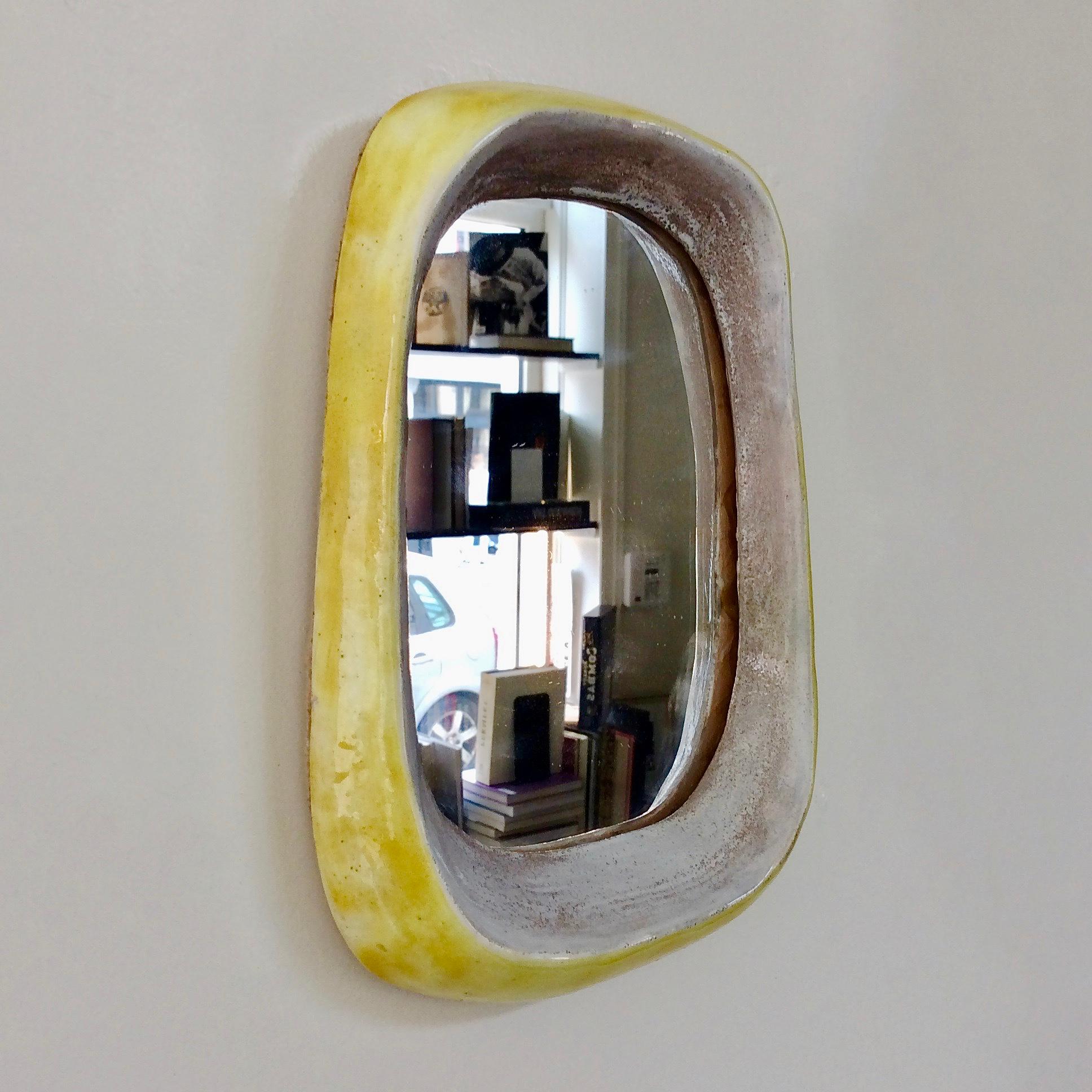 Nice freeform ceramic mirror, circa 1970, attributed to Denise Gatard, France.
White, grey and yellow glazed ceramic.
Dimensions: 24 cm H, 17 cm W, 4 cm D.
Good original condition.
We ship worldwide.