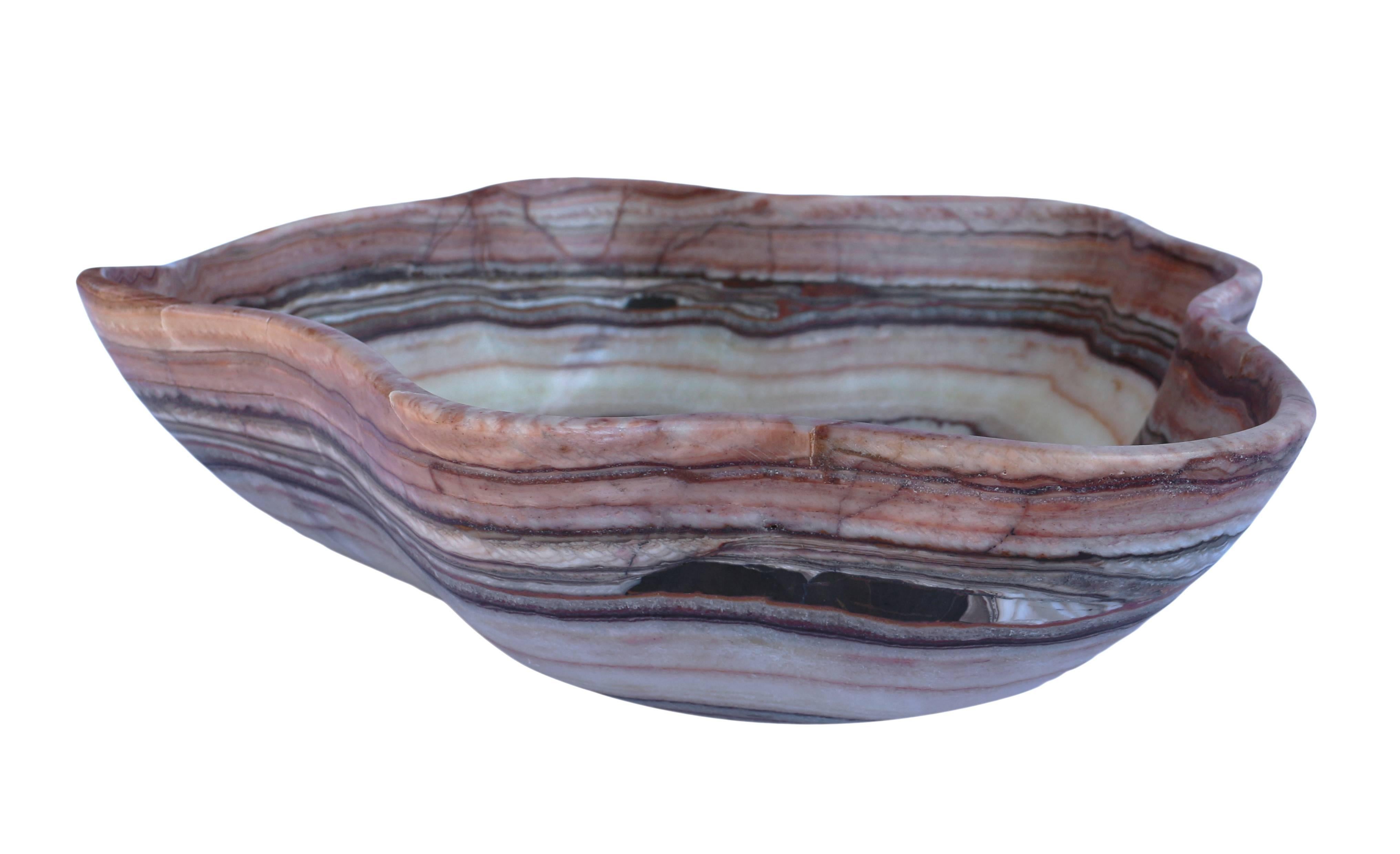Free-form hand-carved onyx bowl. Dimensions are approximate due to variations in the natural shape and height.