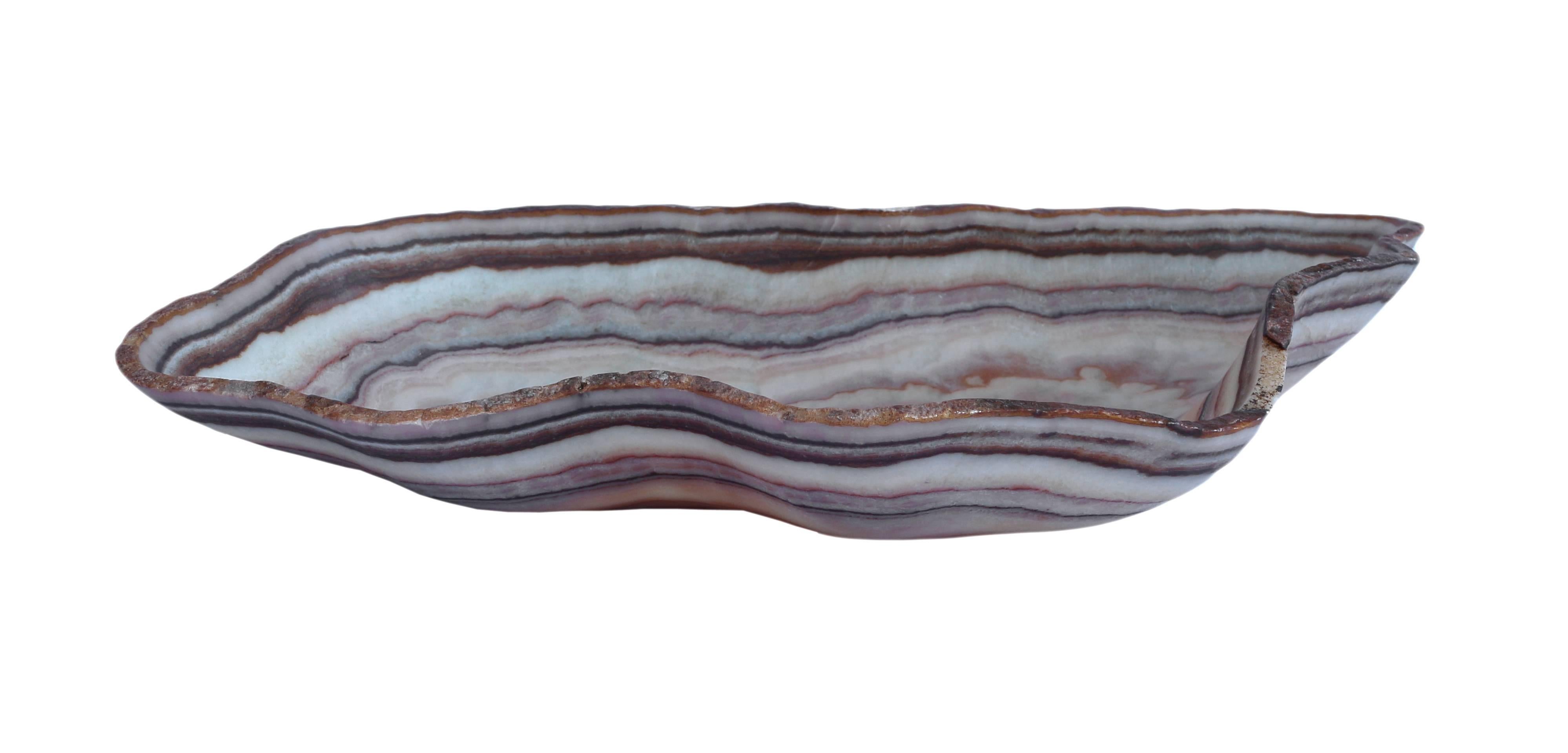 Free- form hand-carved onyx bowl. Dimensions are approximate due to variations in the natural shape and height.