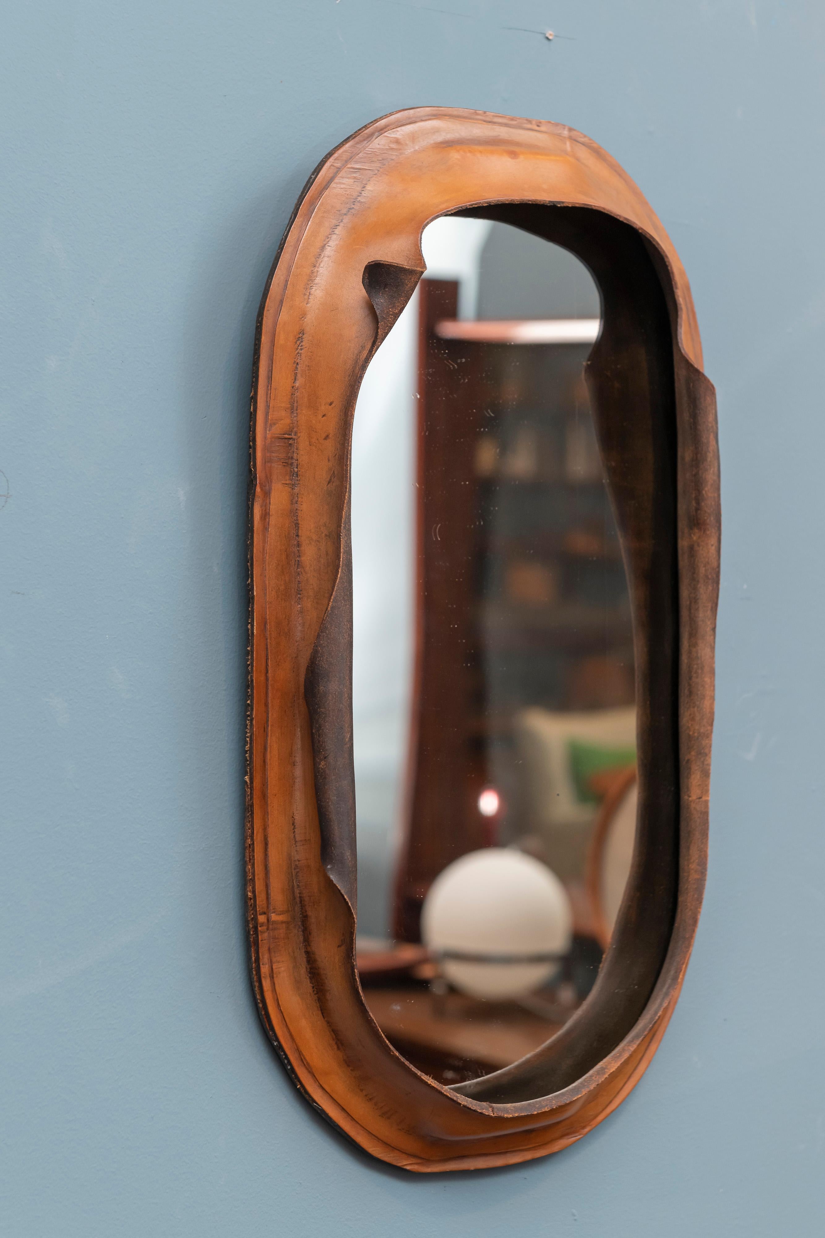 Freeform leather wall mirror, interesting design most likely from the 1970s and either French or Italian.