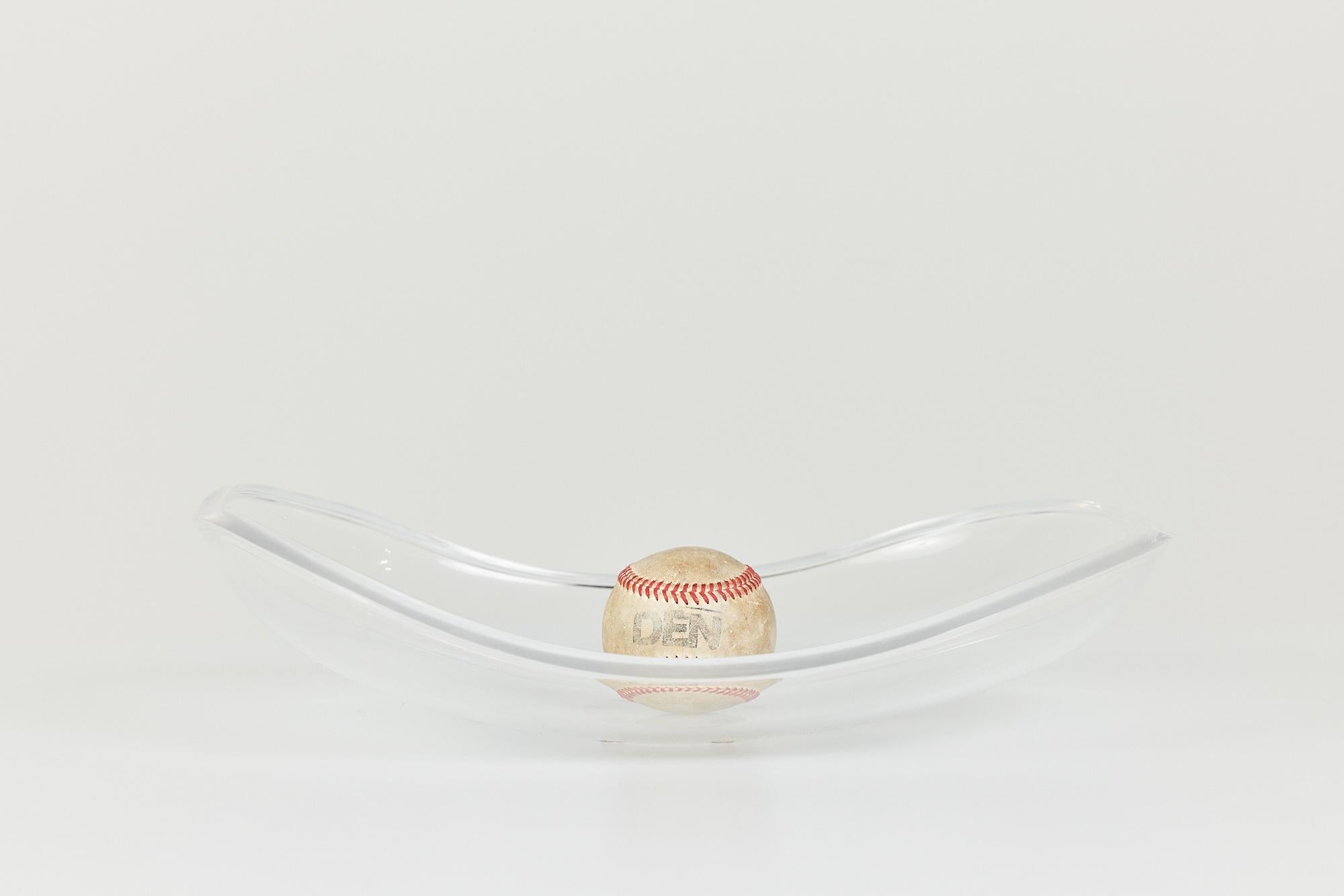 Lucite bowl by Ritts Co., c.1970s, USA. The bowl features a concave center that allows it to serve as a vide poche, catchall, or fruit bowl.

Dimensions: 16