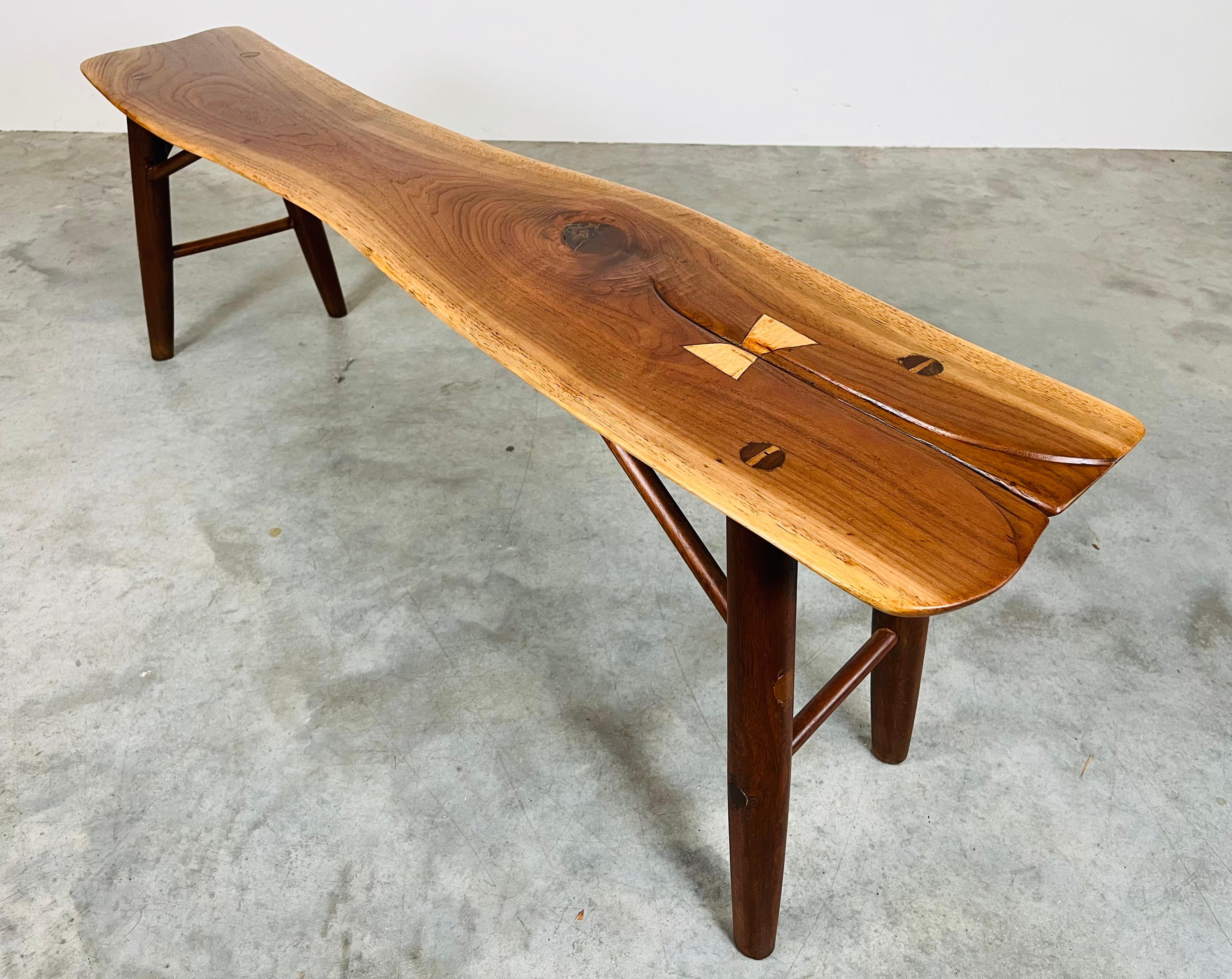 A beautifully hand carved Freeform studio bench in solid walnut by master craftsman Herbert Millstone circa 1963. Millstone was known to host lunch parties for the likes of Paul Evans, Phil Powell and George Nakashima as they would discuss their