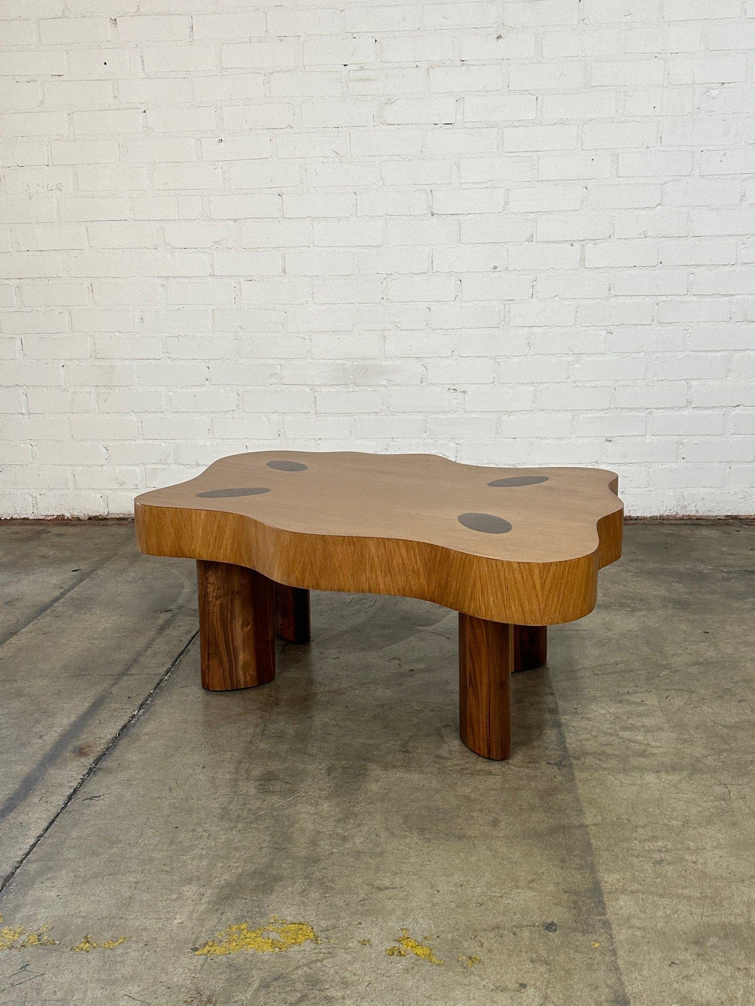 W51 D44 D27 H18

More compact version of our Free Form Coffee Table.

Made from a white oak veneer for the major of the surface with solid walnut oak legs that come up through the surface. This coffee table has been clear coated and shows natural