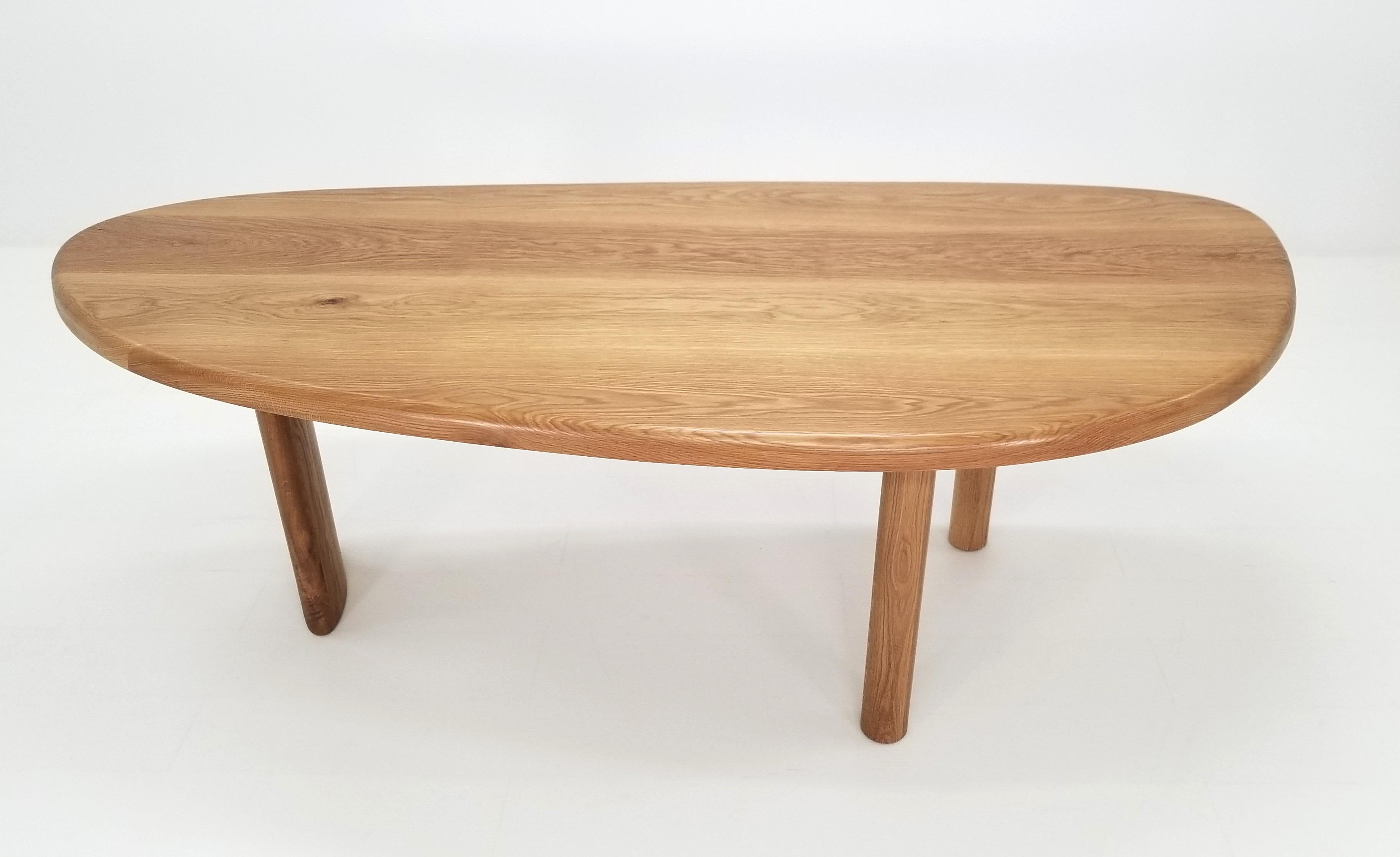 Inspired by Charlotte Perriand's Free Form Dining Table, this table is made with premium hardwood. The hard-wax oil finish adds a golden tone to the white oak. This design features an organic-shaped, two-inch thick table top and solid white oak