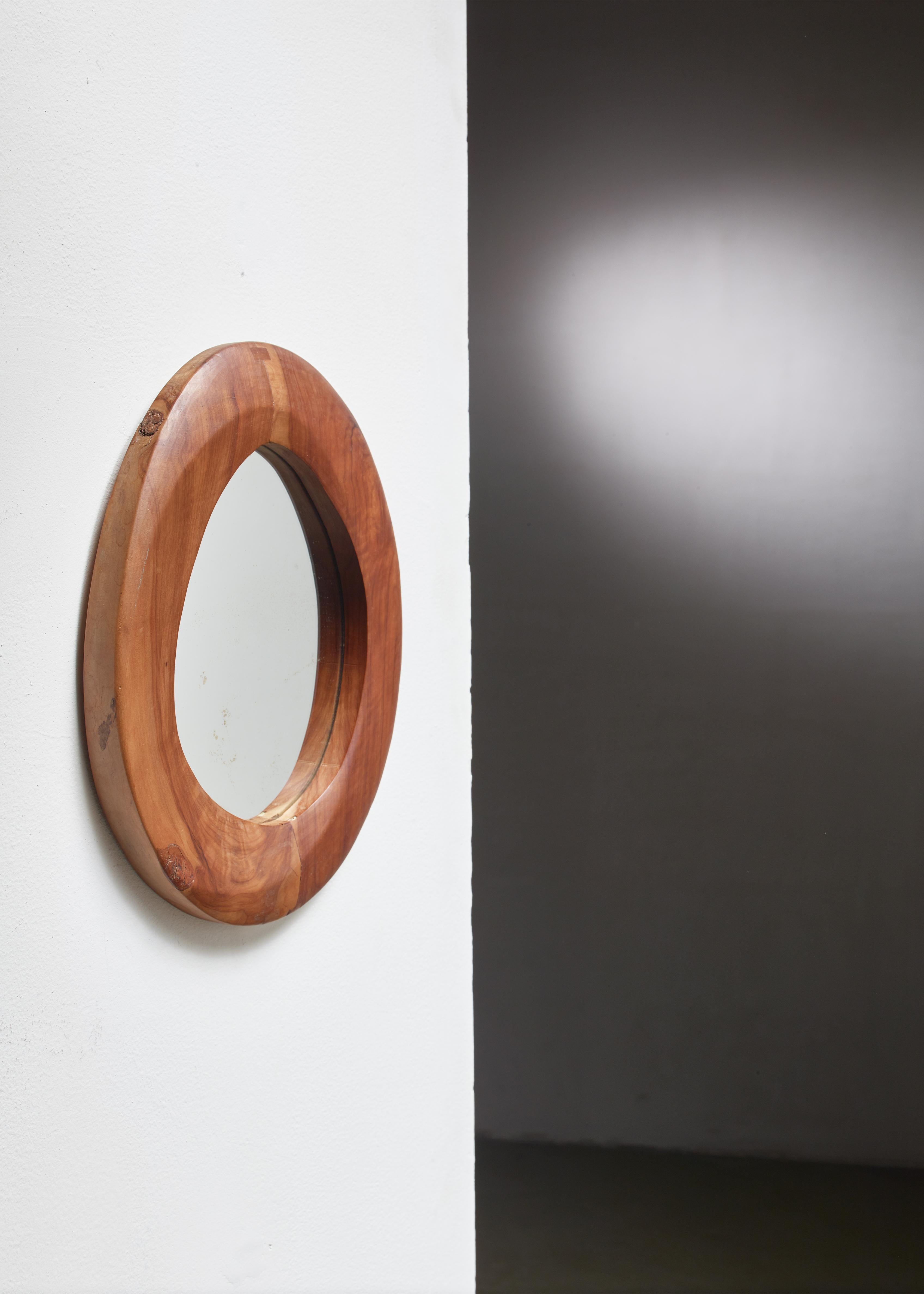 A free-form wood mirror from France. The oval frame shows the skill and style of French woodworkers like Alexandre Noll.
 