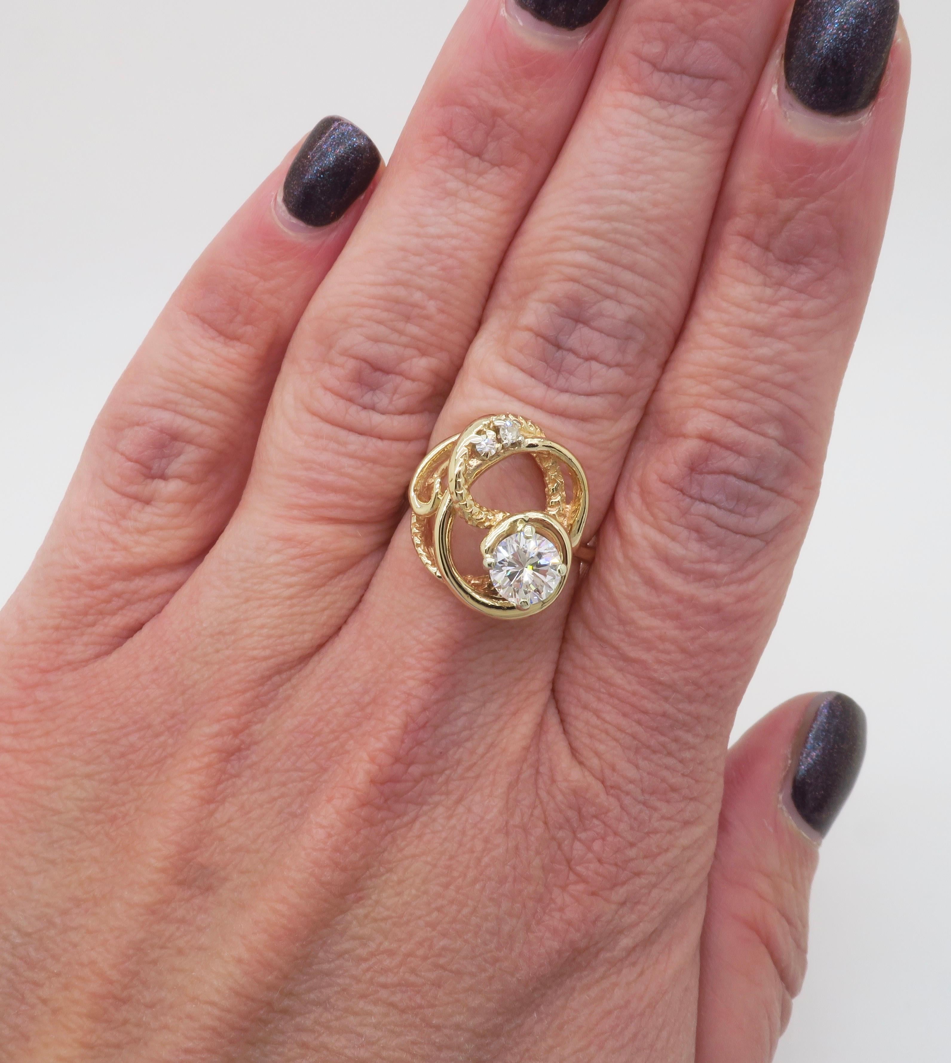 Elegant and unique Diamond free-form ring made in 14k yellow gold. 

Center Diamond Carat Weight: .80ct 
Center Diamond Cut: Round Brilliant Cut 
Center Diamond Color: G
Center Diamond Clarity: VS2
Total Diamond Carat Weight: .88CTW
Accent Diamonds: