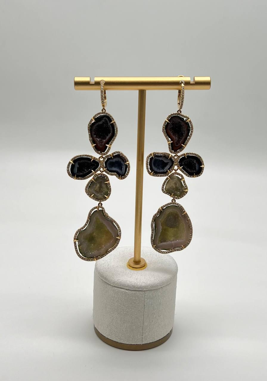 18k Gold Dangle Earrings are a striking display of elegance.

These earrings feature uniquely shaped stones, each set to highlight their natural beauty.

Crafted with care, the organic design creates a captivating silhouette.

The earrings' length