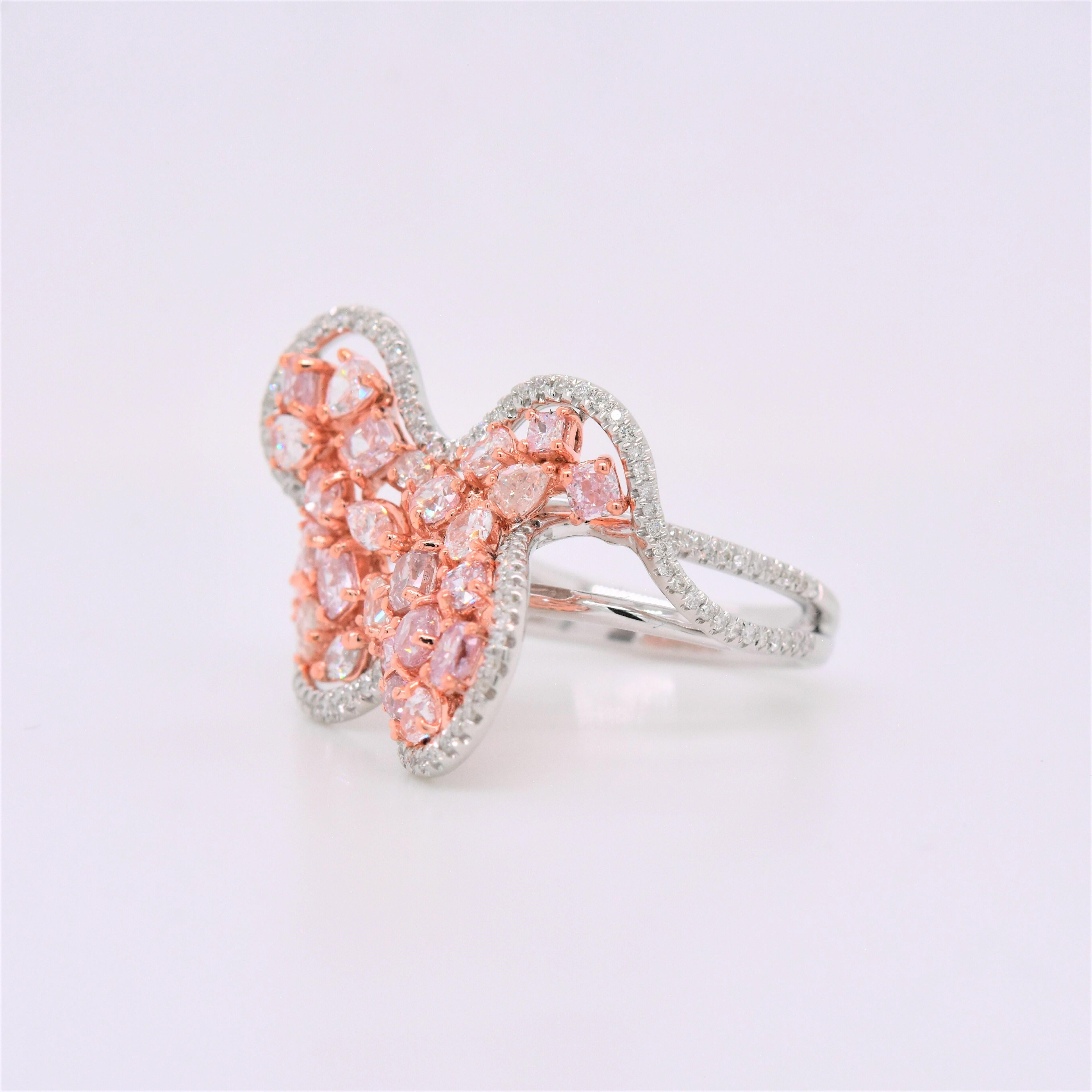This sparkling diamond ring is an absolute delight to own. It showcases free shape motifs embellished with pavé-set with Natural Pink Diamonds sitting at the center of an elegant bypass shank. A dazzling set of round diamonds adds to the luxurious