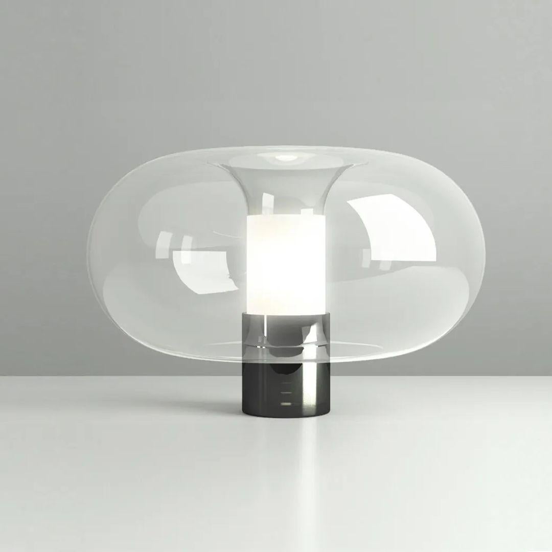 The Fontanella Table Lamp from FontanaArte presents personalized Italian craftsmanship, showing off luminous artistry. Designed by Federico Peri, this contemporary masterpiece marries a rounded shade of crystalline glass with a simple central
