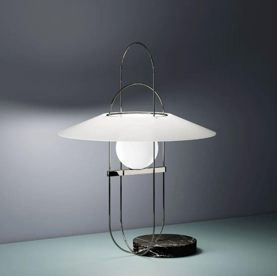 Setareh - Medium Table Lamp - Marble Base W/Black Metal Wire, White Glass Shade

Designed by Francesco Librizzi, the Setareh LED Table Lamp from FontanaArte is a celebration of light and elegance. Each lamp features a glowing glass sphere suspended