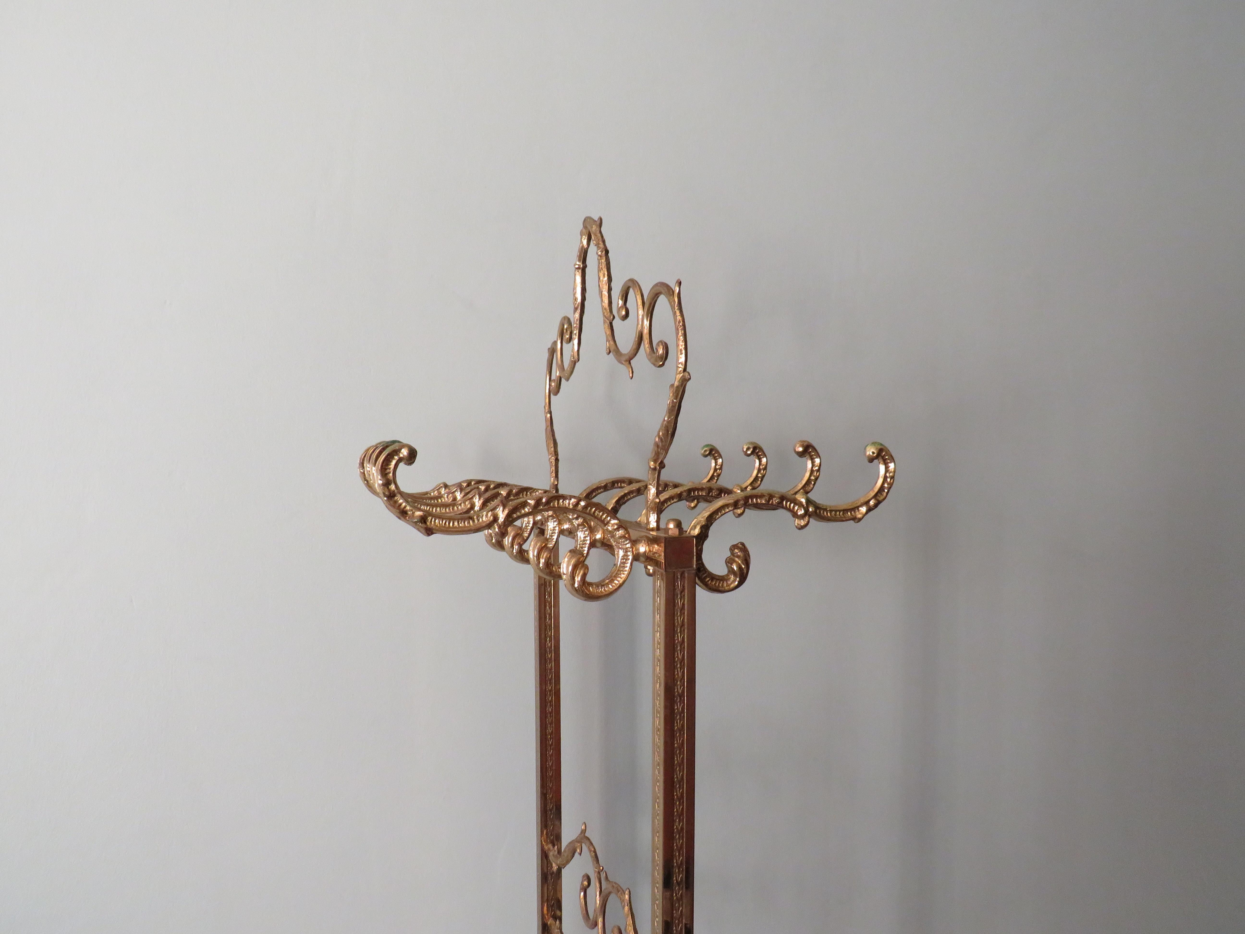 Remarkable double free standing coat rack in gold colored metal.
The coat rack is richly decorated with fish figures and can be used on both sides.
 