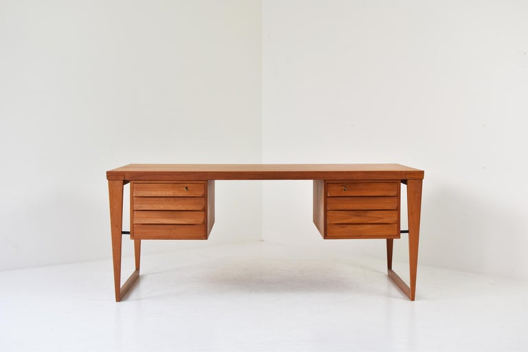 Free-standing desk by Kai Kristiansen for Feldballes Møbelfabrik, Denmark 1950s. This is Model No 70 made out of teak. Lovely triangular shaped runner legs. Two compartments of drawers are mounted symmetrically under the top. Restored with love.