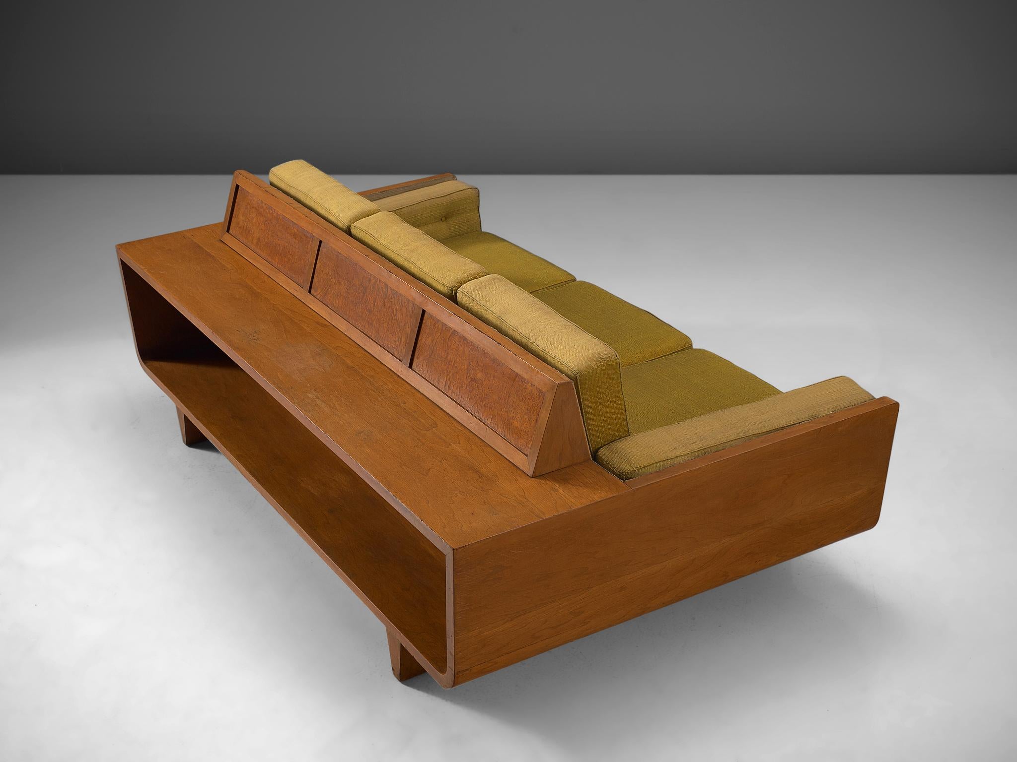 Sofa, walnut wood with green fabric, Italy, circa 1950.

This sculptural sofa is executed with walnut and has several removable cushions that are covered in a green fabric. The frame of the sofa is geometric and has pyramid legs that work well