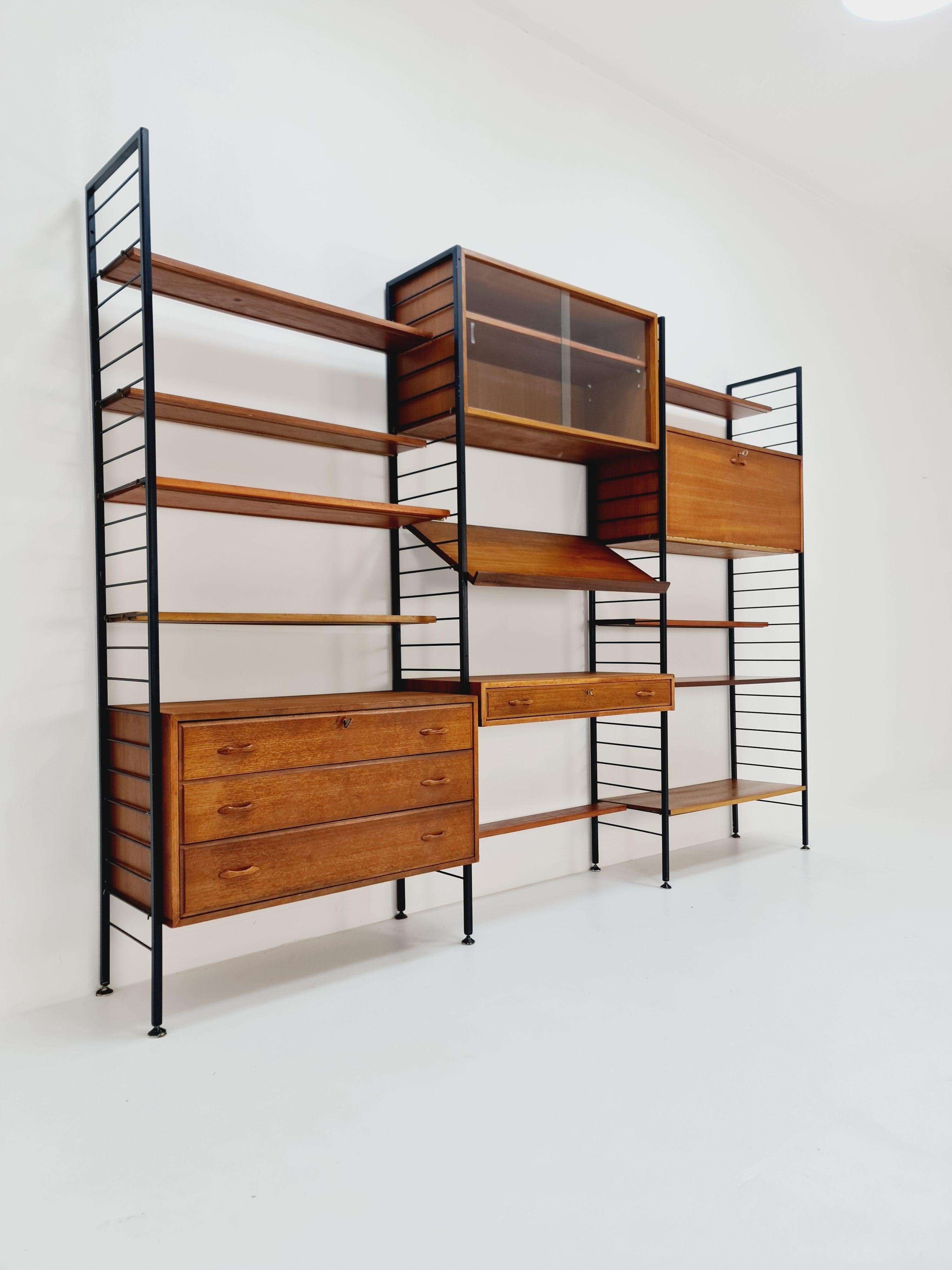 Free standing Mid century vintage modular unit shelving system by Staples Ladderax, London,  1960s

Designed by Staples and C.O.LTD London, Marked

Modular -- The individual units and shelves can have multiple configuration options - Featuring a