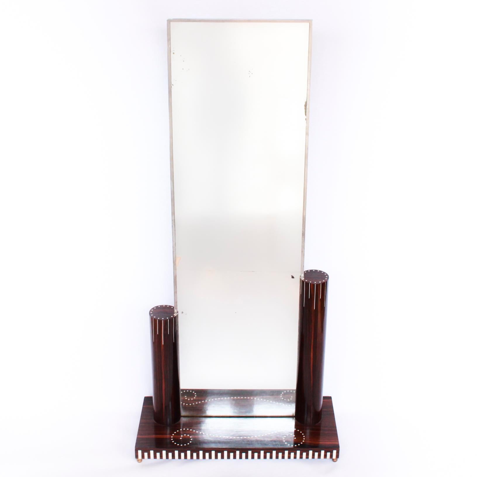 Free standing mirror after Émile-Jacques Ruhlmann. Mirror with metal frame, set into an asymmetric, pillared base of Macassar ebony veneer over oak. Ivory inlaid detail.

Origin: French,


