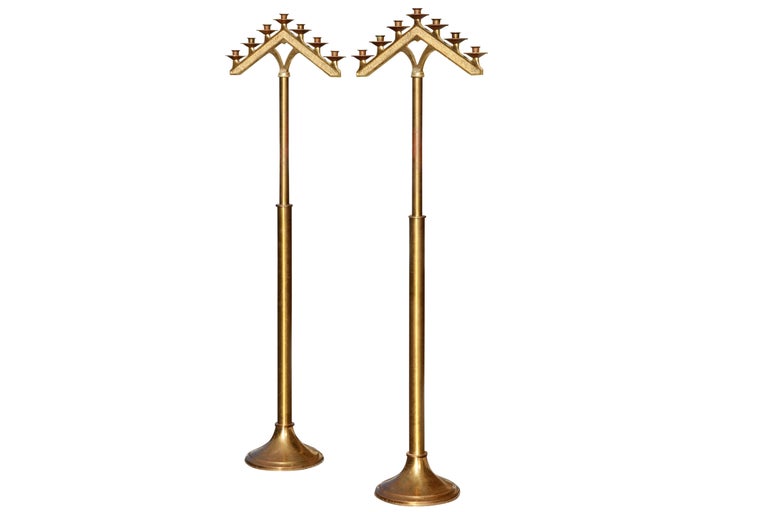 A pair of free standing, gold metal seven branch temple floor menorah. An old symbol of Judaism, the seven branch menorah is seen in artwork, carvings and synagogue decorations the world over. Dimensions per menorah.

 