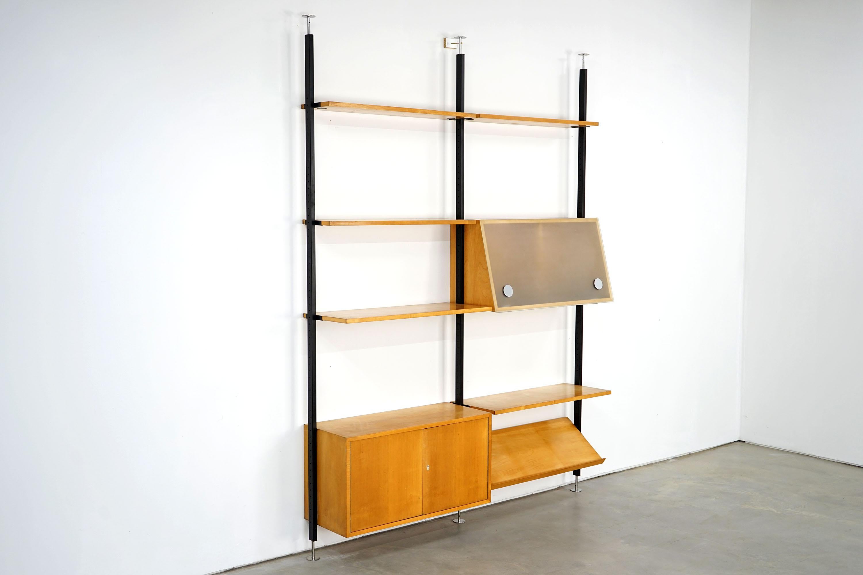 Functional, flexible and simple, this free-standing shelf system is designed by Ulrich P. Wieser for Bofinger-Wohnbedarf AG. Consisting of seven shelves, two cabinets and a newspaper rack, the shelf is an absolute eyecatcher. The black lacquered
