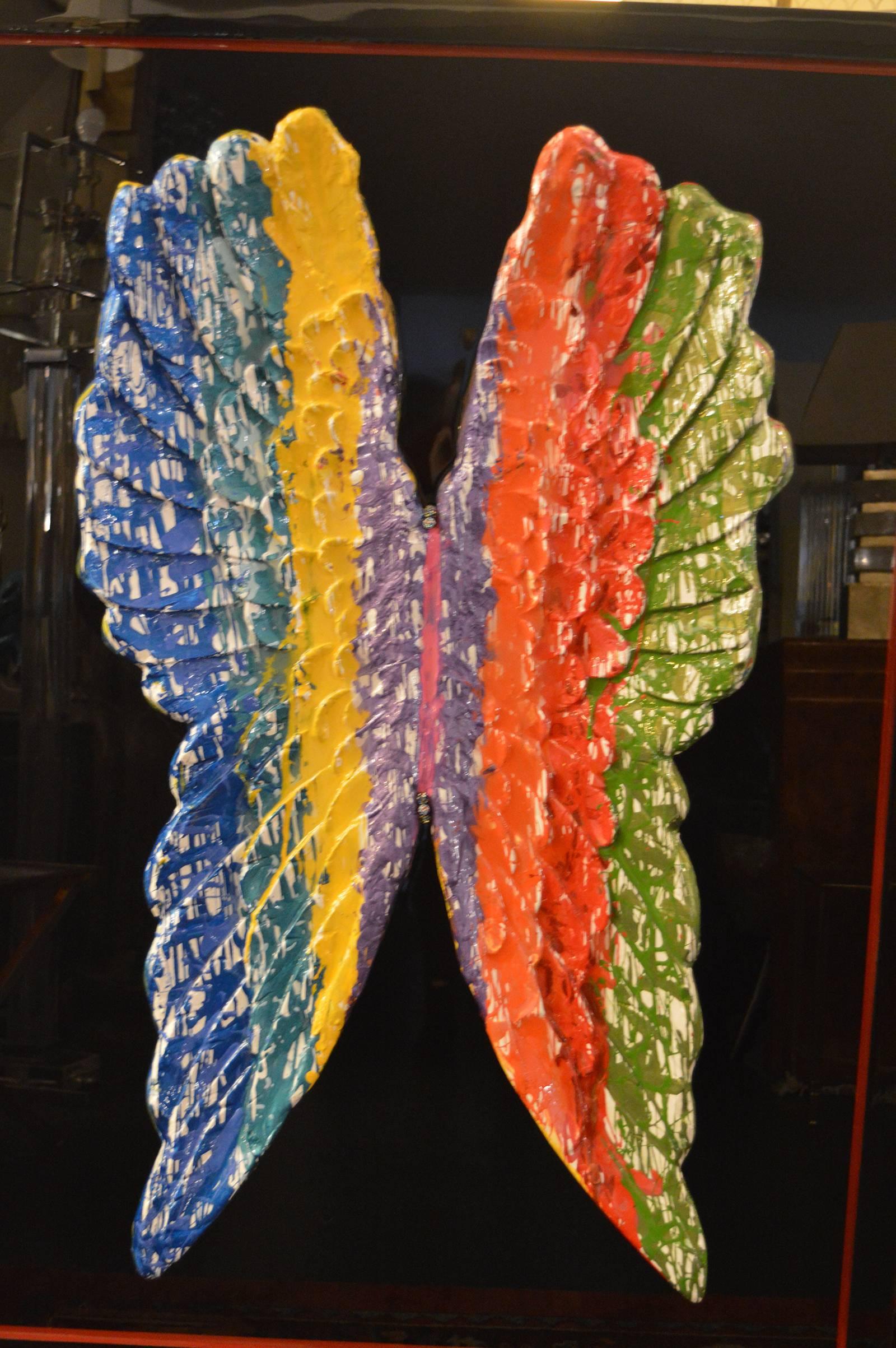 Paint dripped wings covered in resin.