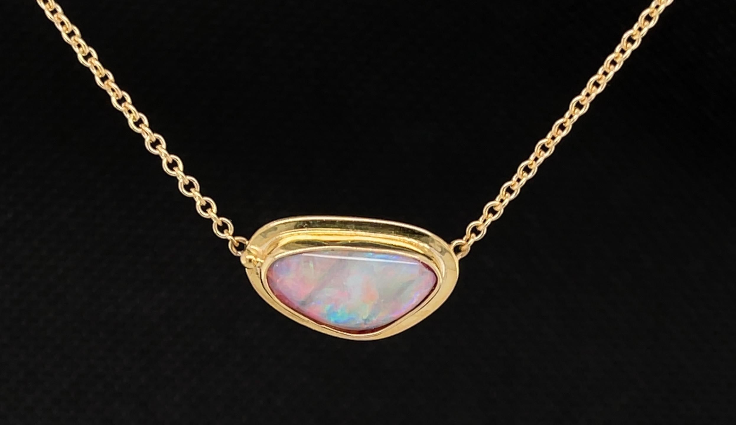 This pretty necklace features a colorful Australian opal set in an 18k yellow gold bezel, suspended by a sparkling 18k yellow gold chain. The opal is freeform in shape, measuring 9.00 x 8.00mm - the perfect size for wearing everyday as a nicer