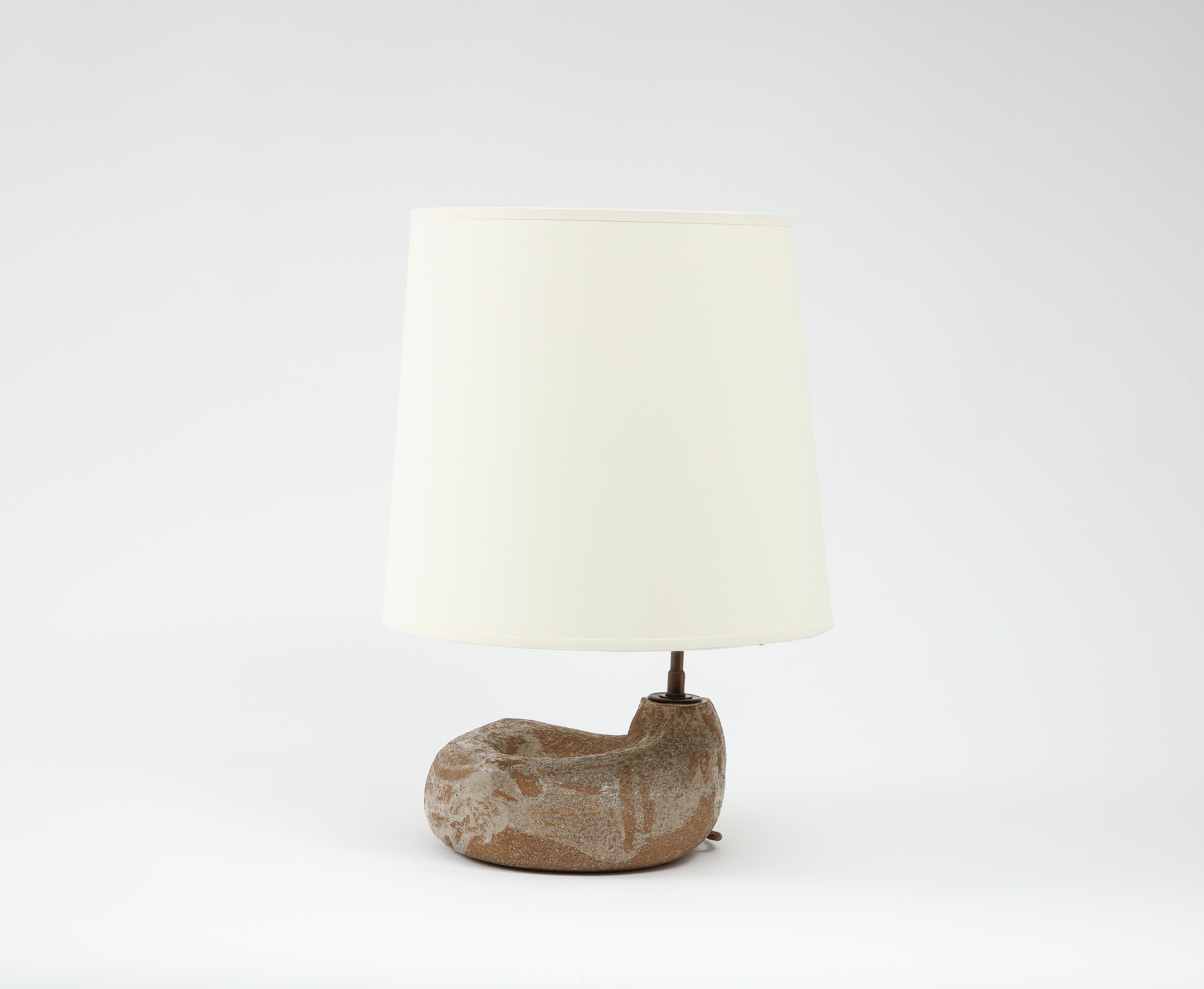 Freeform ceramic lamp, the body in a cup form with an offset stem. Rewired with a silk cord, it comes with a custom shade.