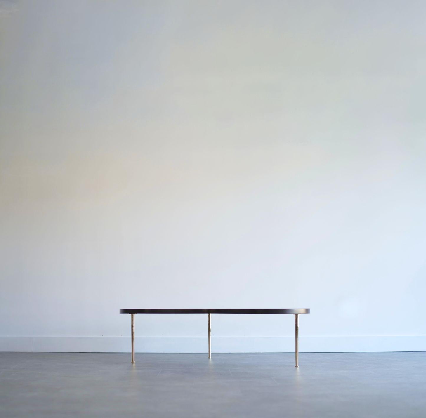 An iconic design by T.H. Robsjohn-Gibbings for Widdicomb (1950, USA), this sculpted walnut and brass Freeform cocktail table (Model 1759) embodies organic elegance. Its fluid, cloud-like silhouette rests on delicate tapered brass legs, seamlessly