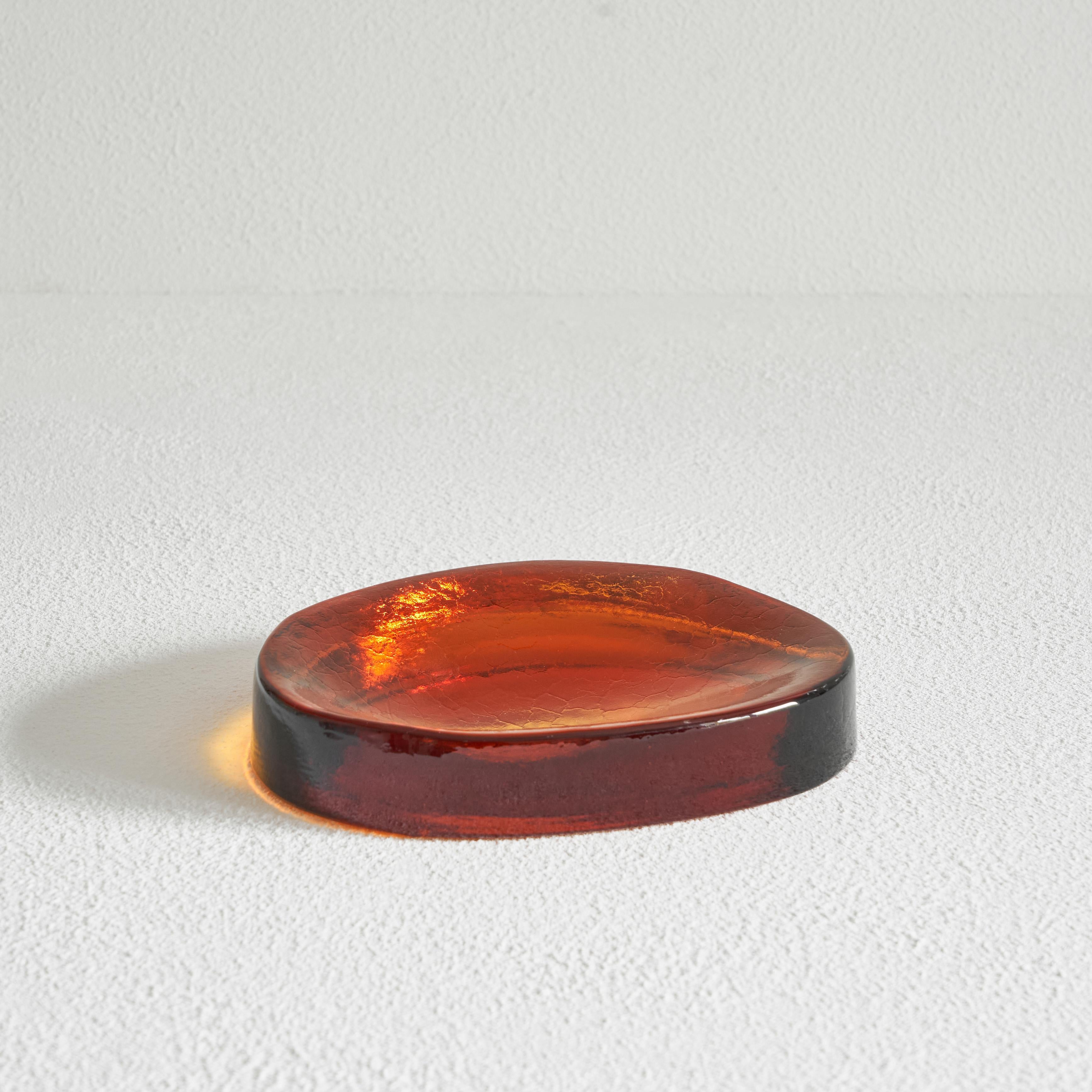Freeform Concave Amber Colored Vide Poche in Solid Glass, 1960s.

Wonderful freeform shaped bowl or vide poche in amber colored solid glass. A real gem with a very deep and mesmerizing color. The solid glass has a very attractive concave freeform