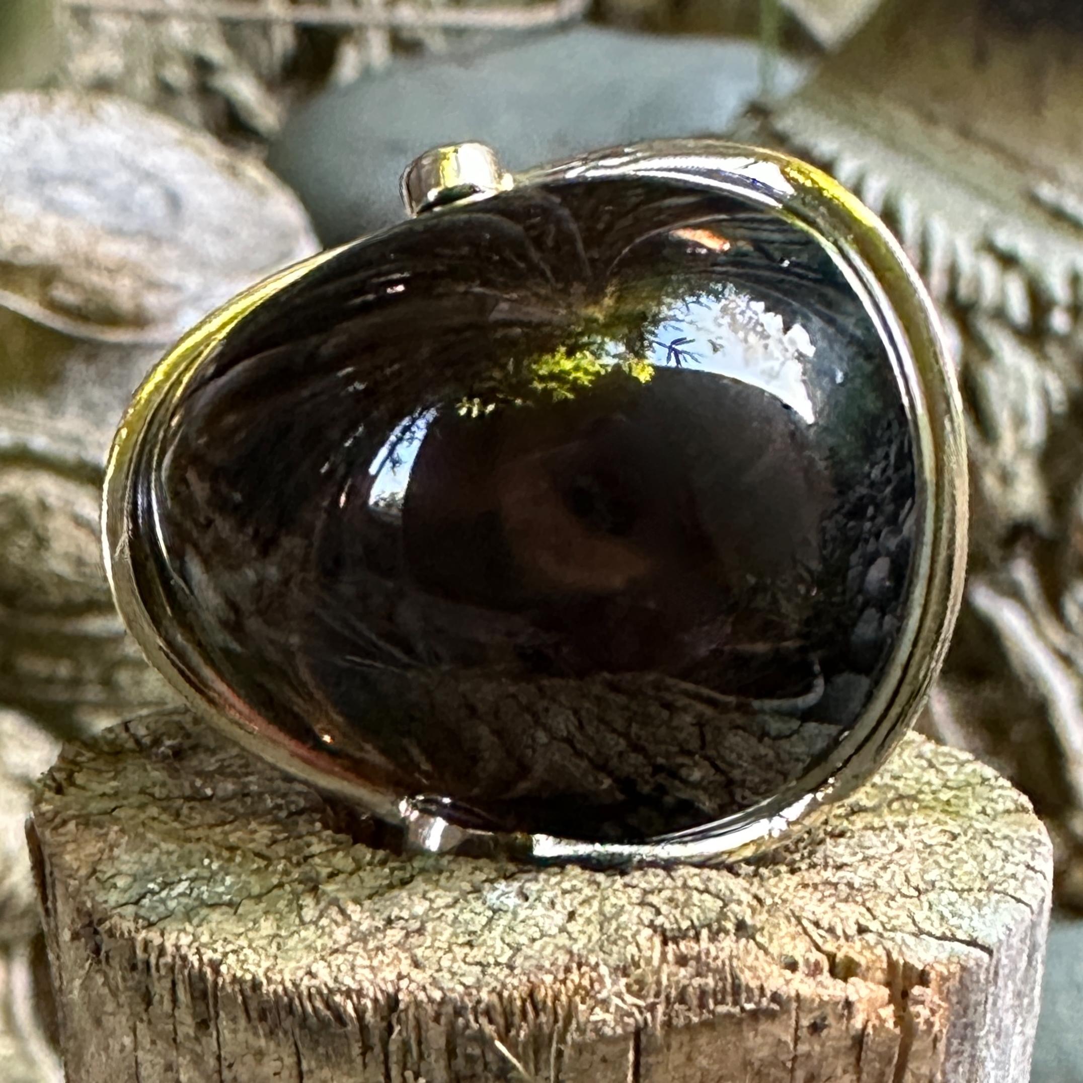 This extraordinary cocktail ring, probably made in the 1990's, features a big root beer quartz, roughly pear-shaped, in a clean and modern 18 karat gold ring.  Oversized bezels at the top and bottom hold small white natural (i.e., earth-mined)