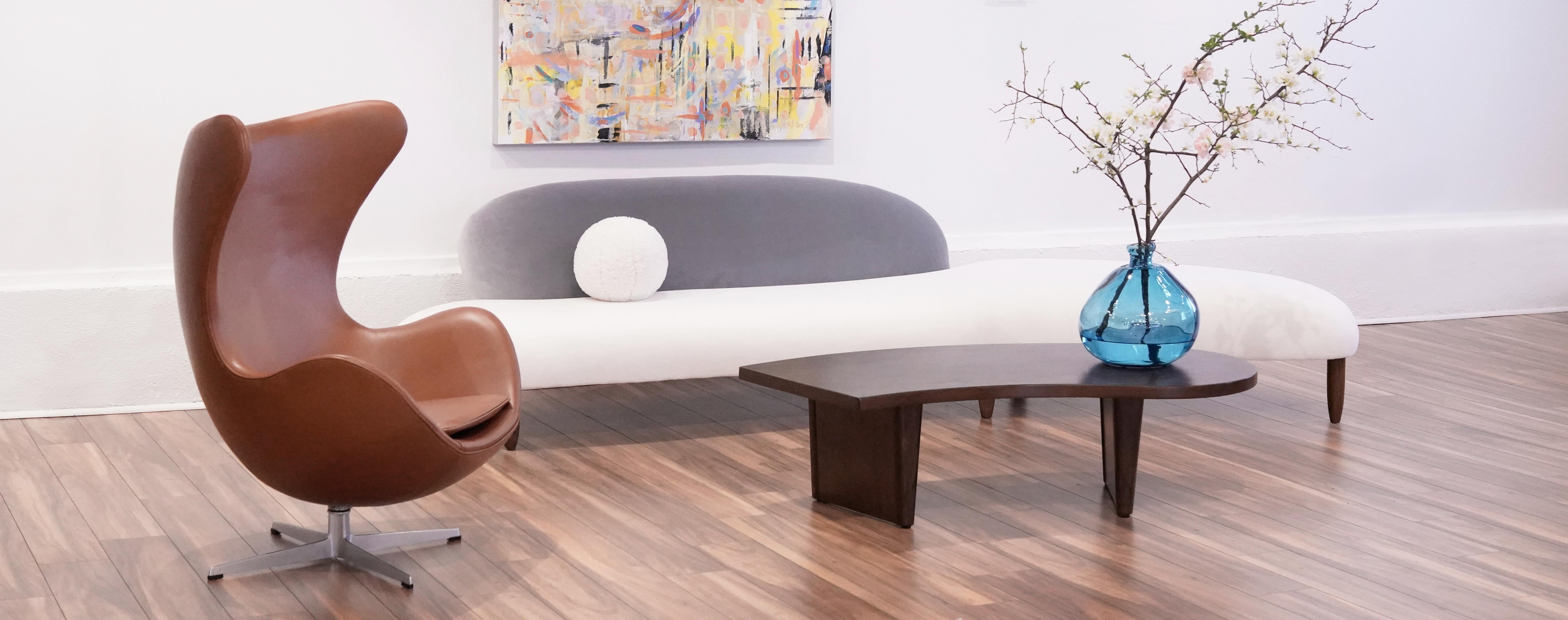 Rare freeform sculptural sofa designed by Isamu Noguchi. Newly upholstered in cotton velvet by Holly Hunt. Walnut legs fully restored.