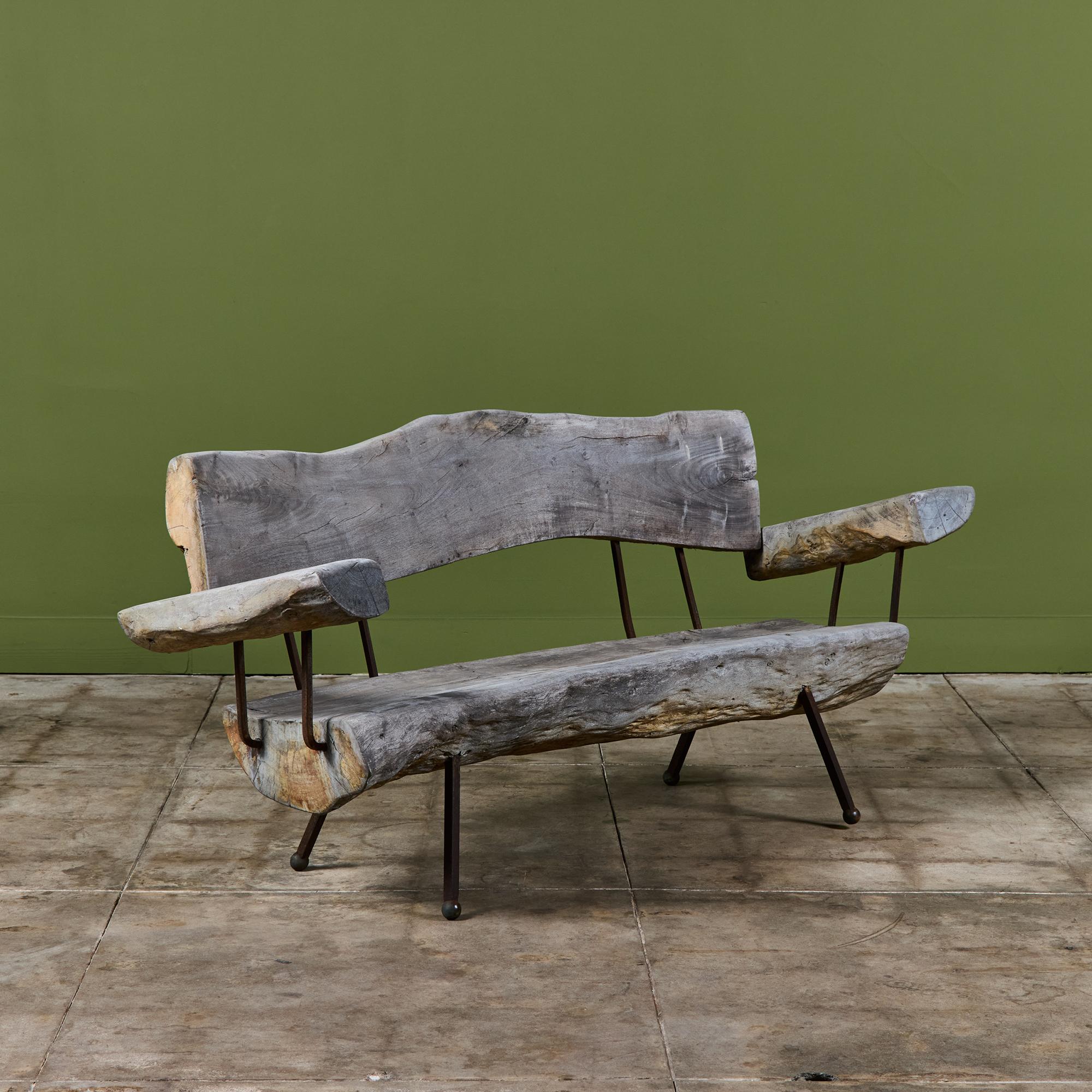 Freeform wood sofa by Sabena of Mexico, c.1960s. The three seater sofa features a freeform wood slab seat and seat back with two armrests and an iron frame with ball feet.

Dimensions
69