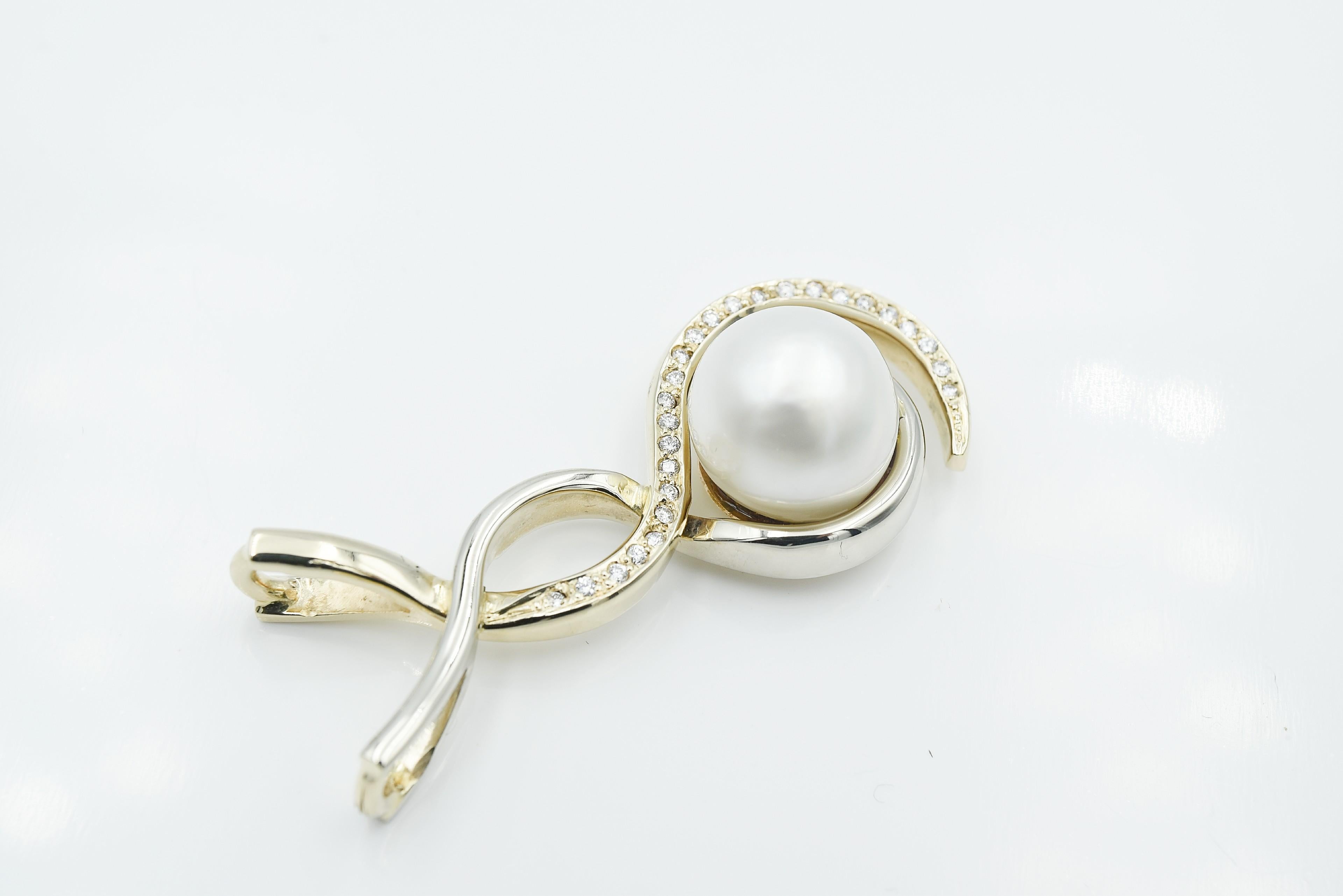 Freeform White and Yellow Gold South Sea Pearl Pendant. This pendant contains a 13.5mm half drilled pearl and .50ct round cut pave set diamonds in a swirl overlapping design.  
