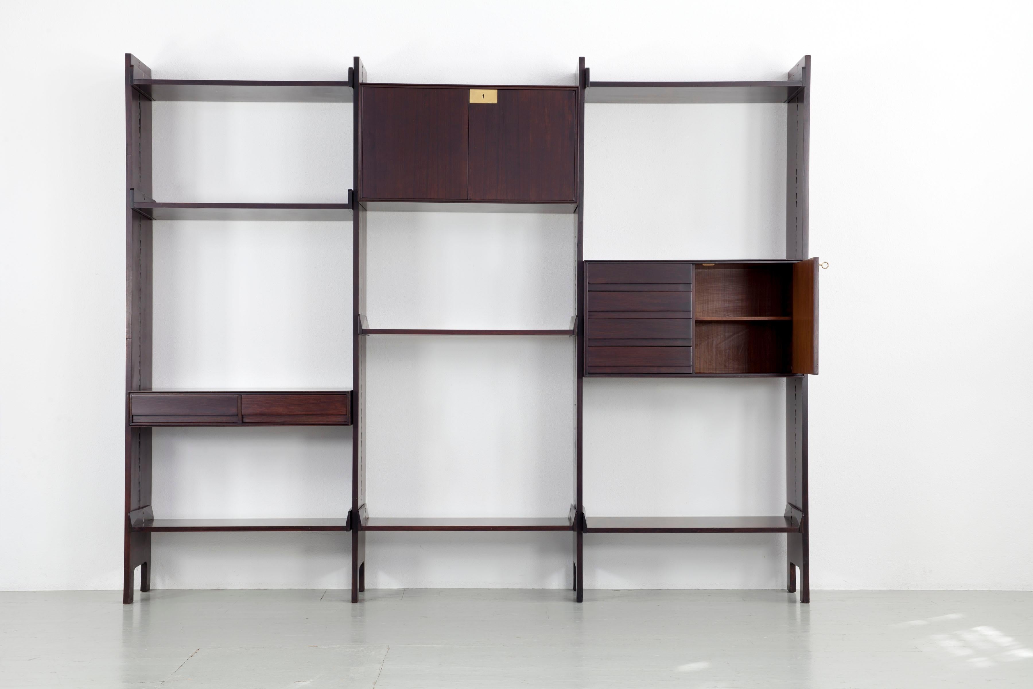 Wall cabinet cupboard - bookcase made of dark stained rosewood, Italy 1960s.
All elements can be variably fixed.
Design: Edmondo Palutari,  Manufacturer: Dassi, Italy 1960s.

Feel free to ask for more photos or information.