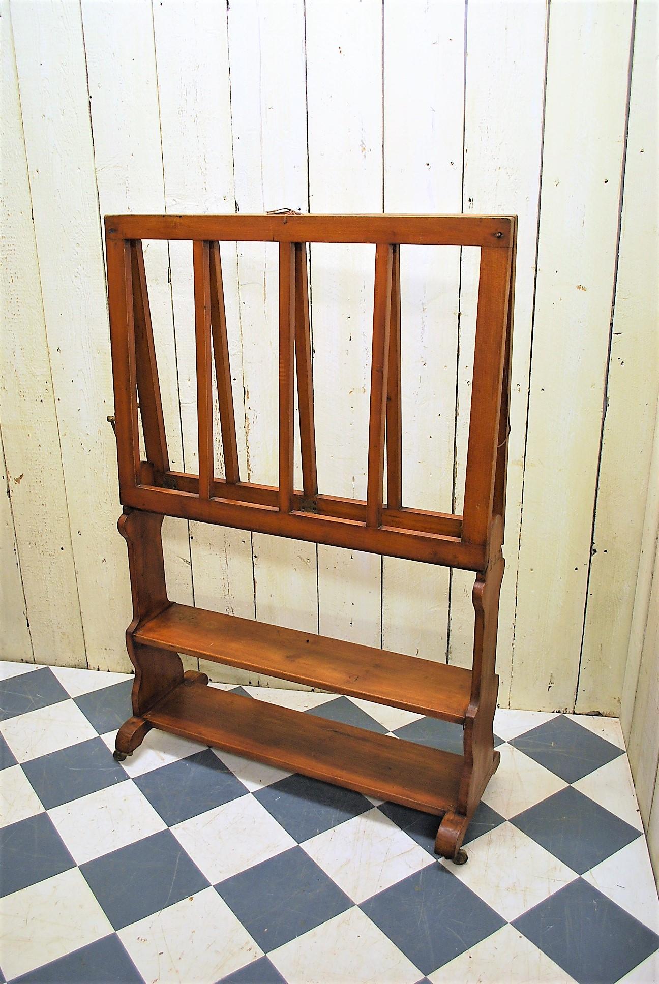 This is a rare French portfolio stand for in a gallery or artists studio. Made in Plain wood and in good undamaged condition with a nice colour and patination. The stand is either tied together closed or opens out for displaying artwork in. Often
