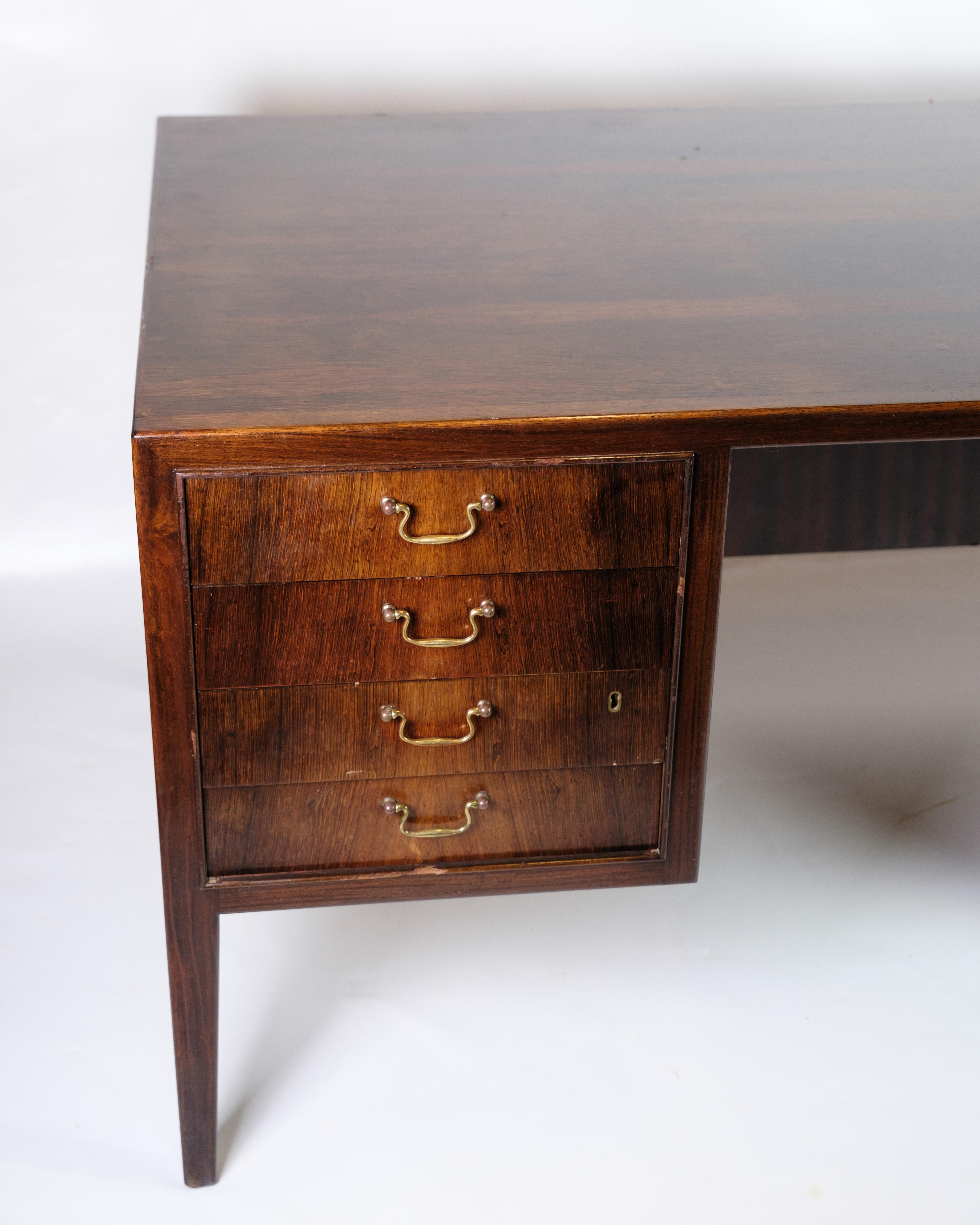 Freestanding desk designed by Jacob Kjær in the 1960s. The desk is made of exclusive rosewood and has eight spacious drawers with elegant brass handles. The freestanding design makes it suitable for placement in the middle of the room, as the back