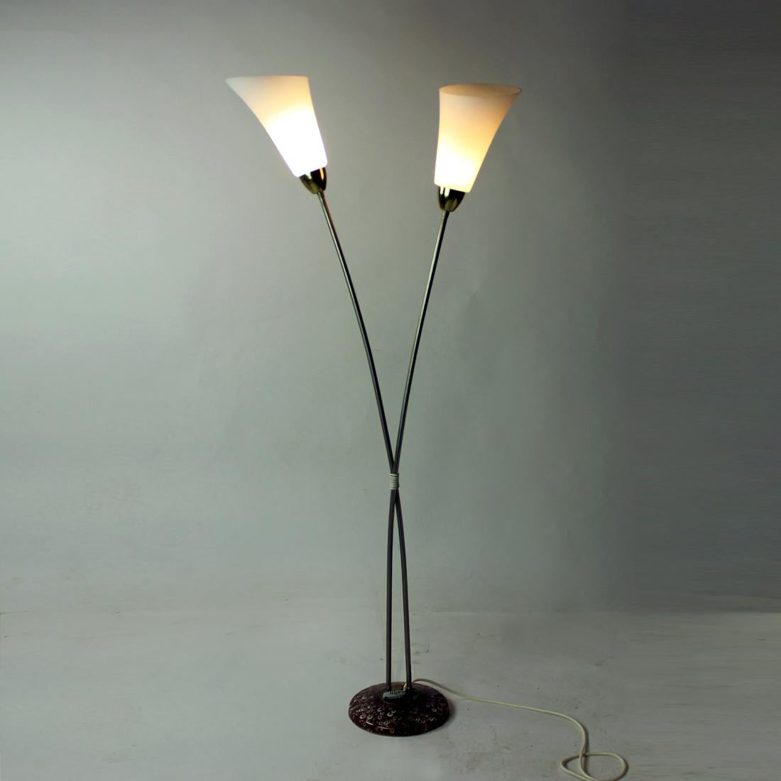 Great, iconic floor lamp produced in Czechoslovakia in 1960s by Kamenicky Senov company. The lamp stands on a ceramic base. Two metal rods are like stems of flowers raising high and are finished with flower like glass shields made of white matt