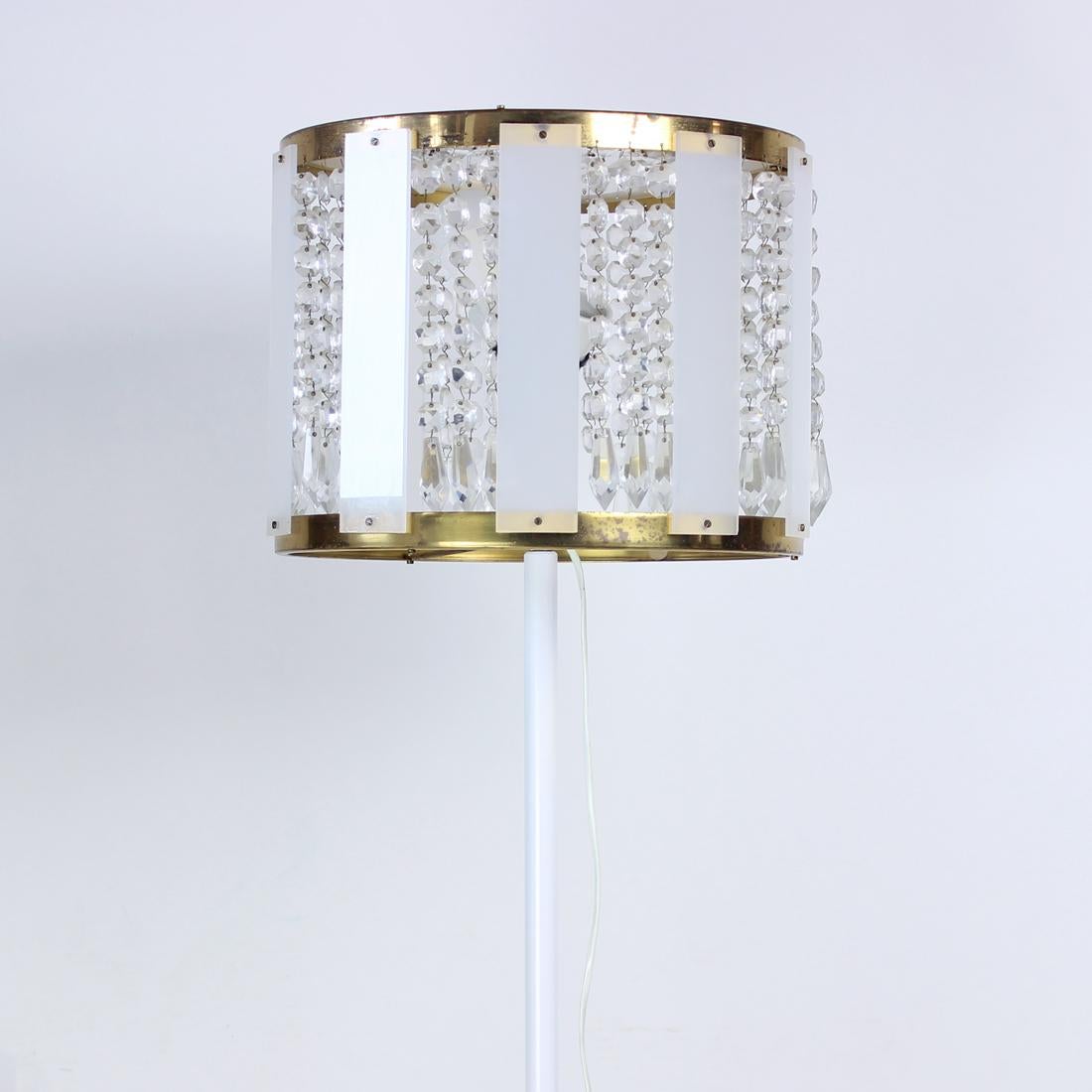 Beautiful, vintage freestanding lamp. Produced by Kamenicky Senov company in 1970s. The company specialized on the cut glass pieces, combining them with newer materials. This lamps is a perfect example of such a combination. Standing on the white