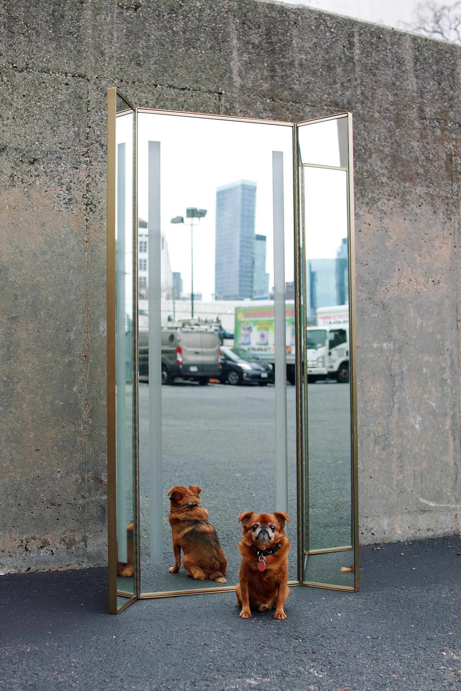 For your consideration is this circa 1990s full length tri-fold dressing mirror featuring a metal frame with original bronze tone finish, full height piano hinges, a large central mirror panel with transluscent frosted detailing, and well-made