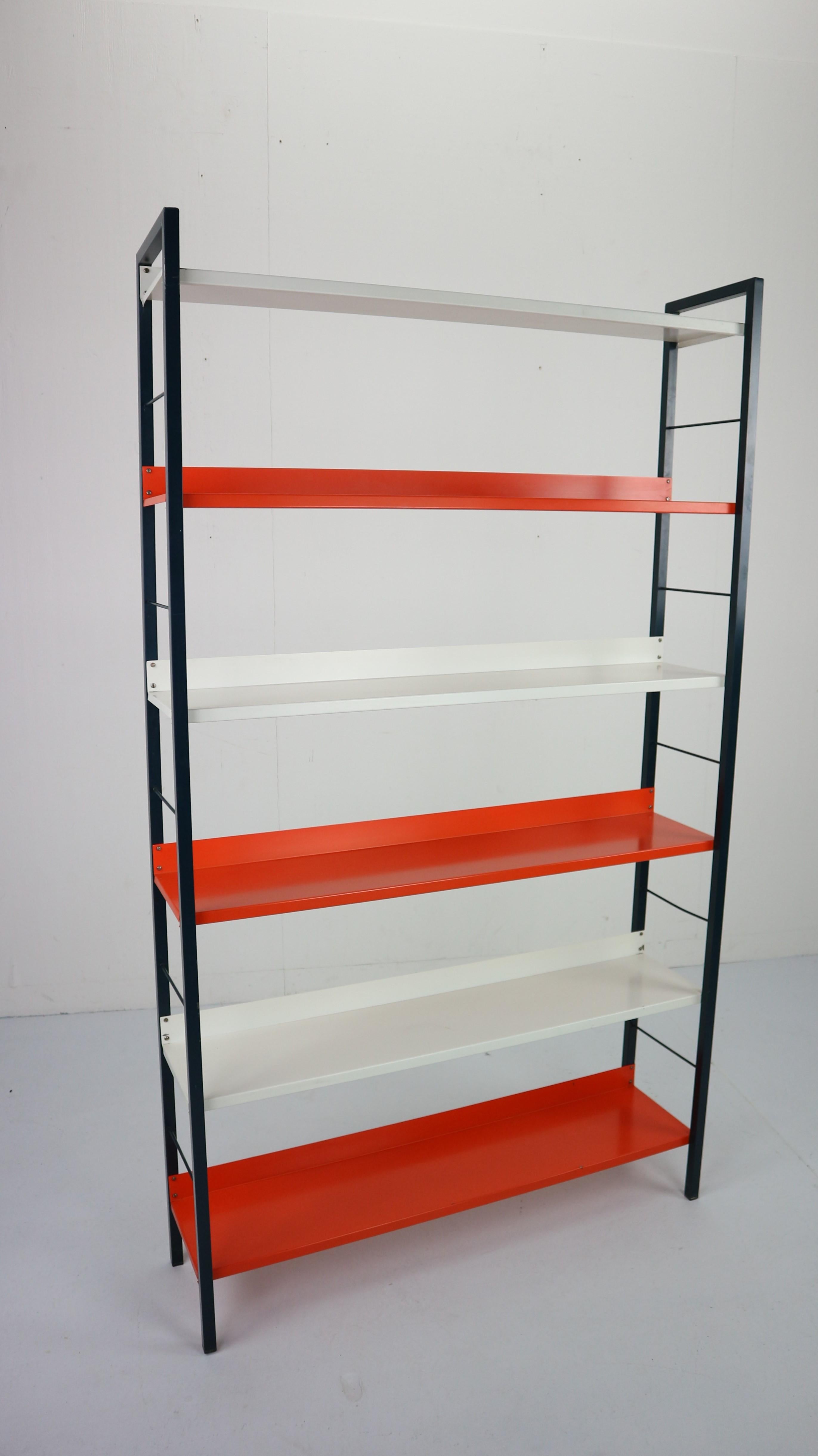 This vintage industrial freestanding metal bookcase was designed by A. Dekker for Tomado in Holland 1950s.
Rare large version with six shelves in orange, white and navy colors.
Typical Dutch modernist design.
In very good vintage condition some