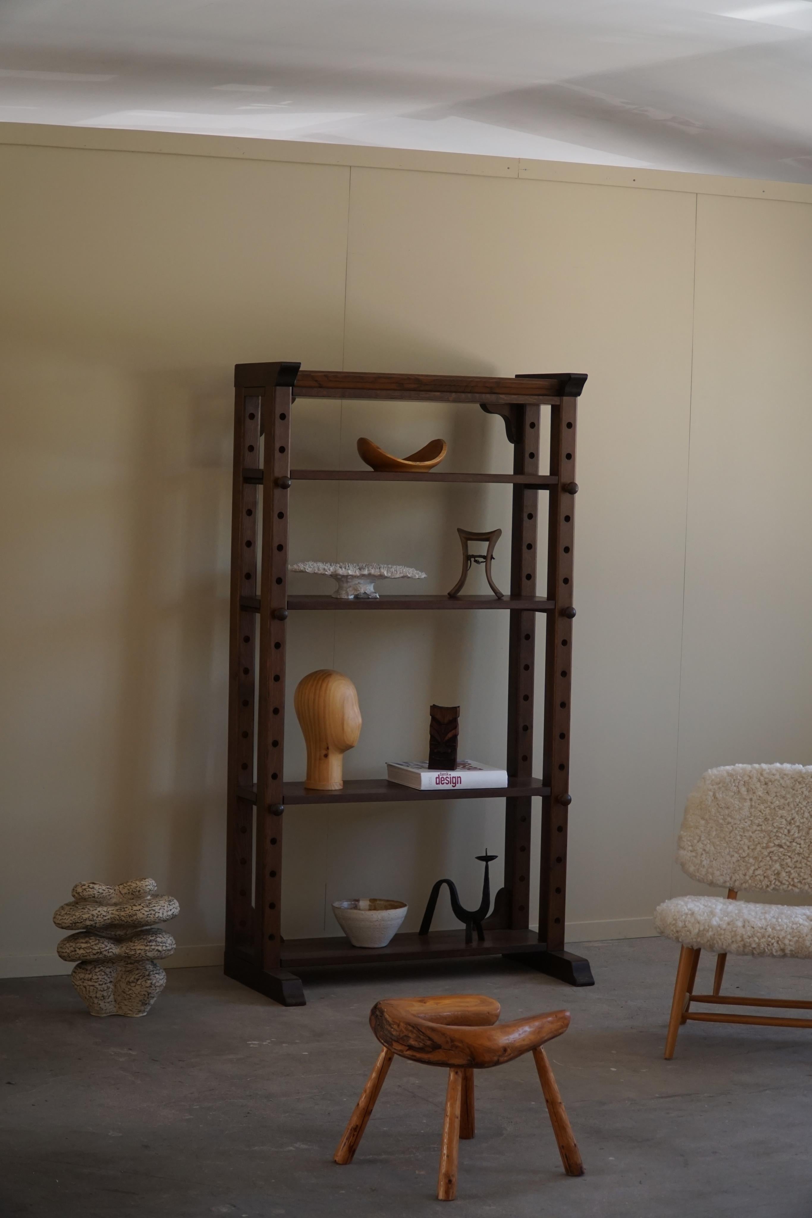 A charming freestanding shelf unit with adjustable shelves, made by a Scandinavian carpenter in the 1960s. 
The shelf unit is constructed from solid beechwood, known for its durability. The natural grain of the wood is showcased beautifully, adding