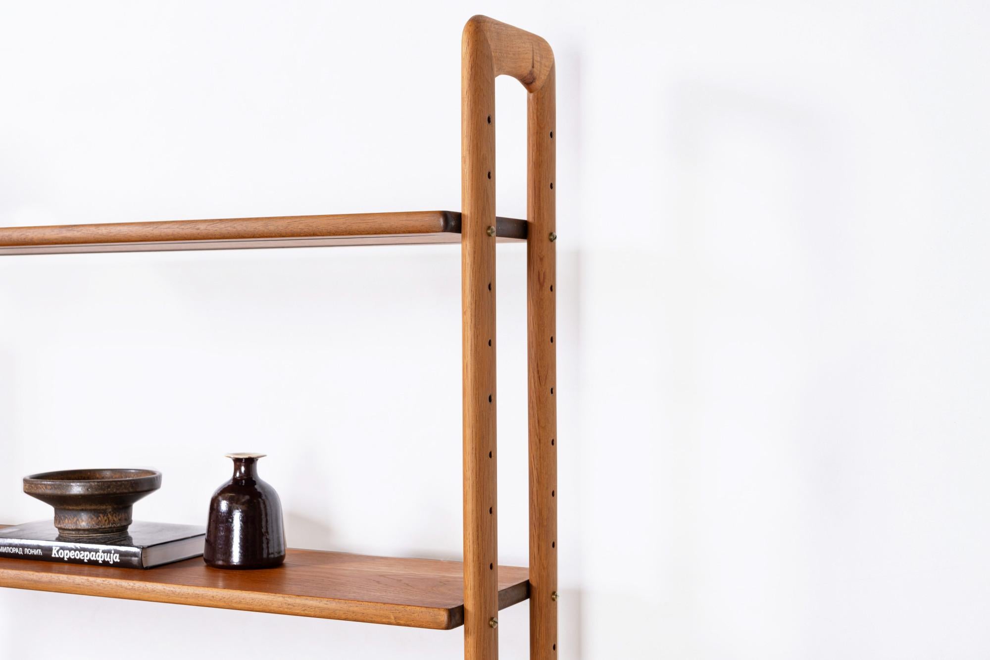 This freestanding bookcase, designed by Kurt Østervig for KP Møbler in Denmark during the 1960s, offers both functionality and style. It features two cabinet elements, one for storage and one for display, along with eight spacious bookshelves. This