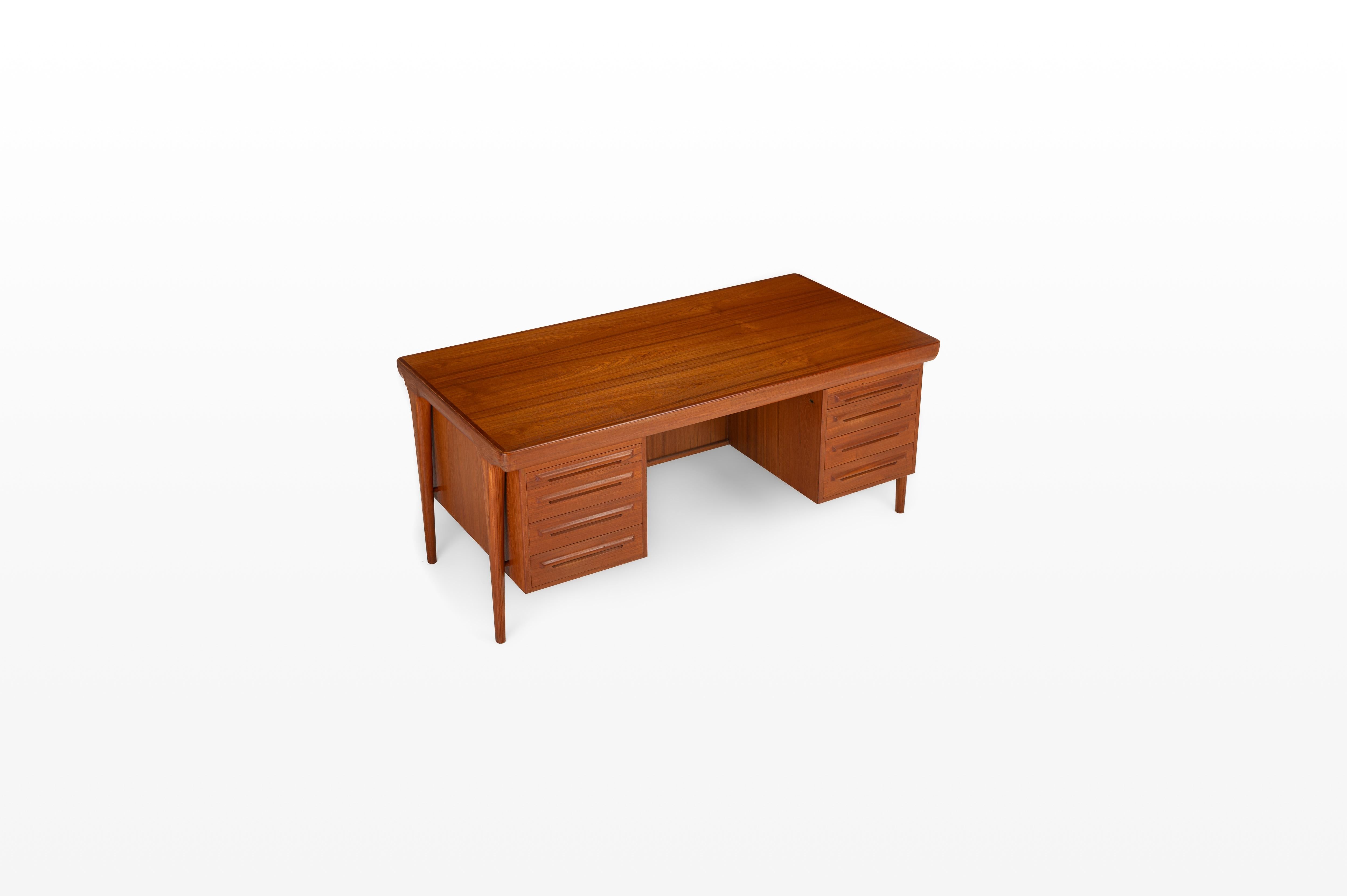 This exceptional desk was designed by Ib Kofod-Larsen for Faarup Møbelfabrik. Produced in the 1960s in Denmark.

Featuring six drawers and two pull-out trays for writing or serving, it combines functionality with timeless design. The back of the