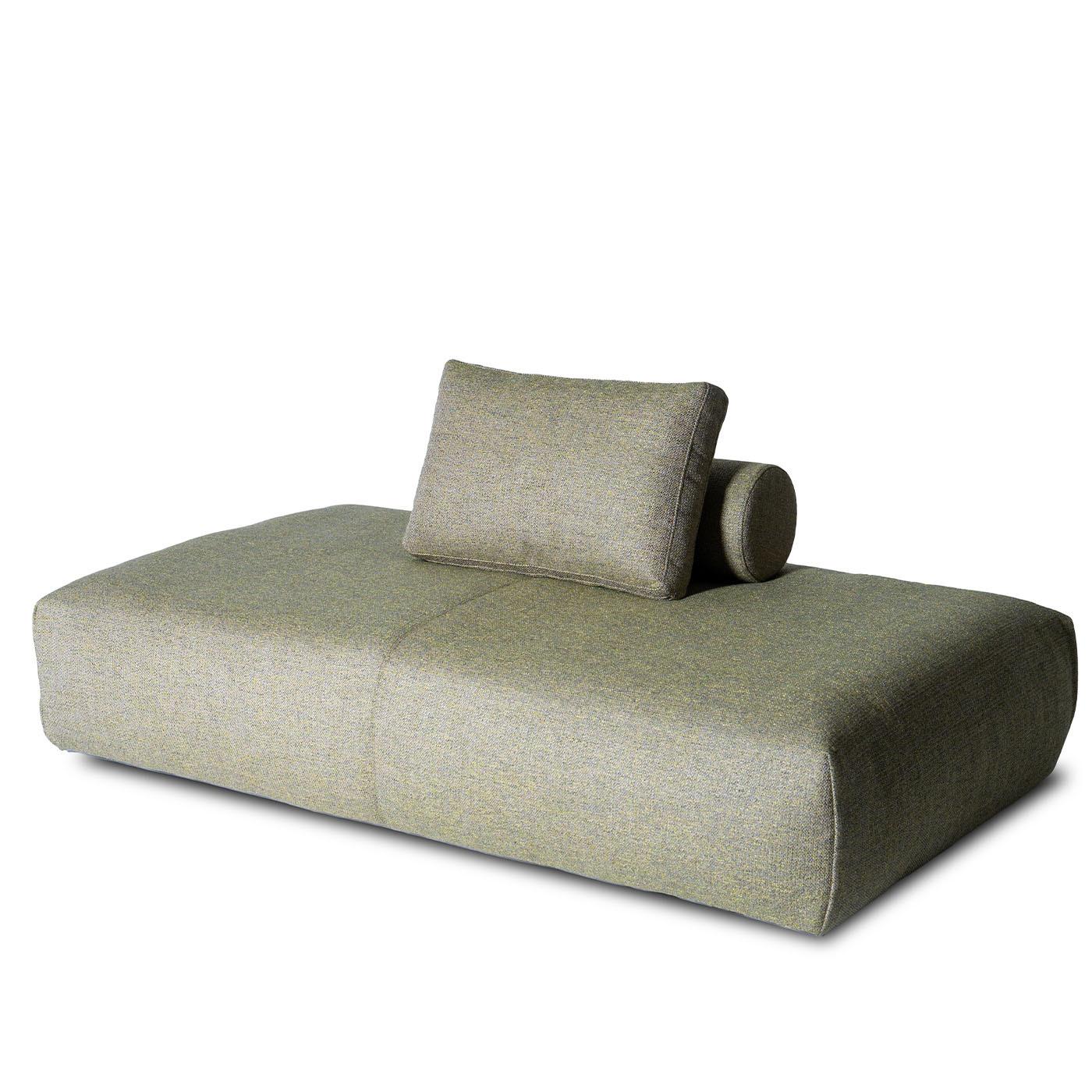 A celebration of modular comfort, this platform sofa features a wide, adaptable seating area with freely positioned backrests for customizable relaxation. Upholstered in soft green fabric, it offers a refined yet inviting texture. The plush seat,