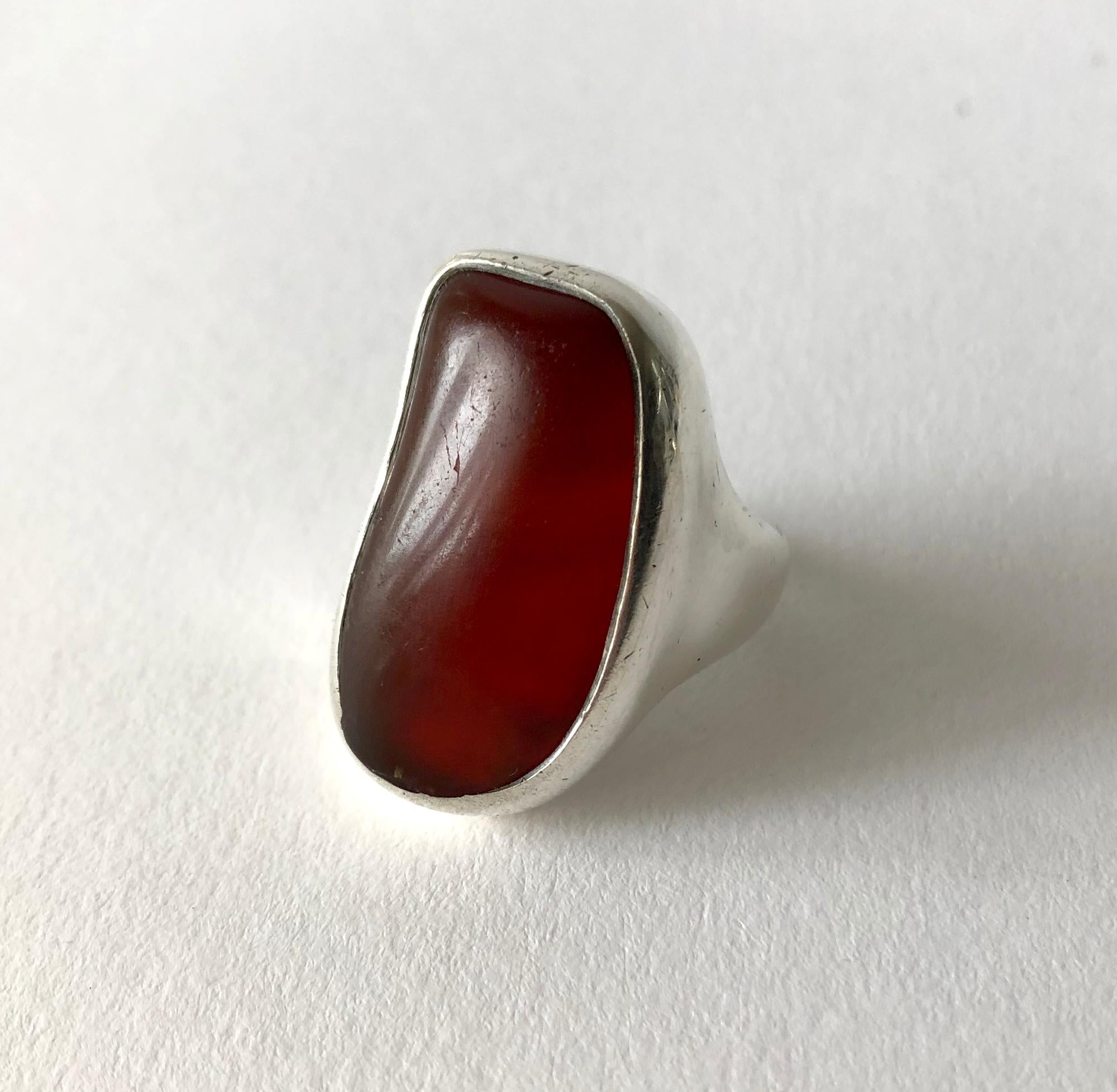Sterling silver and amber gentlemens ring created by H. Fred Skaggs of Scottsdale, Arizona. Large amber stone and setting are amorphic in shape and completely hand made. Stone and silver do have wear. Stone has a divot and scratches which are
