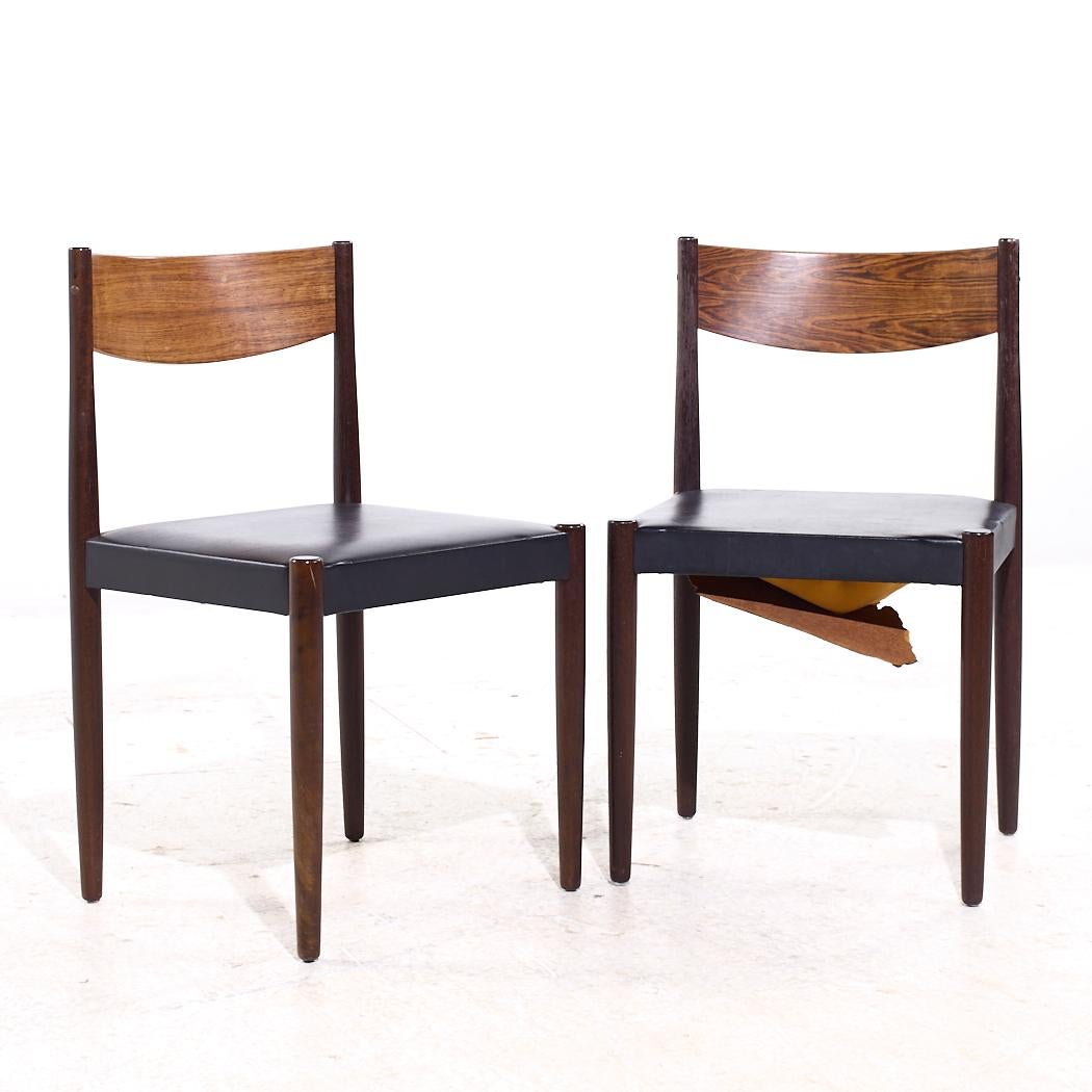 Frem Rojle Mid Century Rosewood Dining Chairs - Pair

Each chair measures: 18.25 wide x 17 deep x 31 inches high, with a seat height/chair clearance of 17.5 inches

We take our photos in a controlled lighting studio to show as much detail as