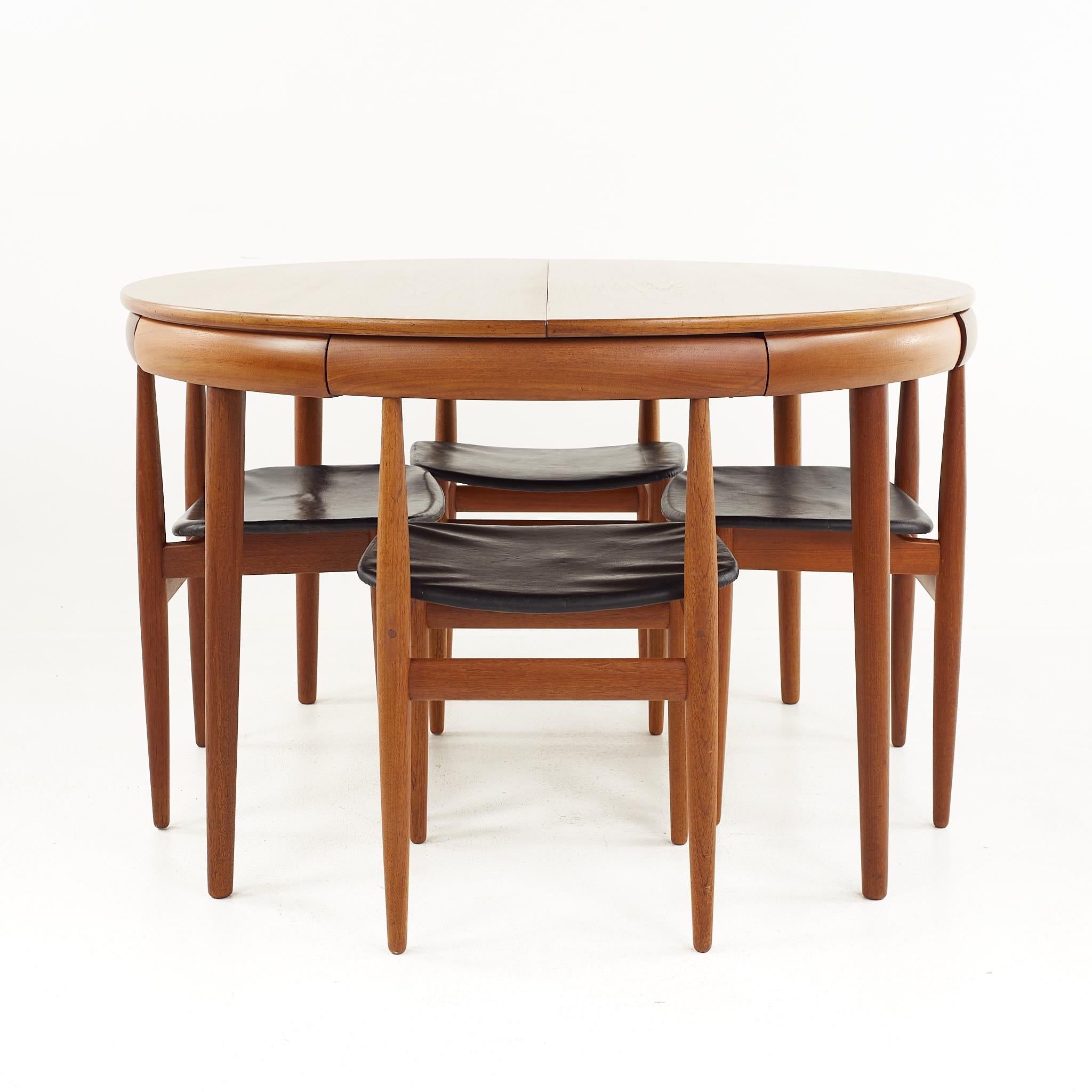 Frem Rojle mid-century teak hidden leaf dining table with 6 nesting chairs

This table measures: 47 wide x 47 deep x 29.25 inches high, with a chair clearance of 26.25 inches

(Chair measurements are pending)

All pieces of furniture can be
