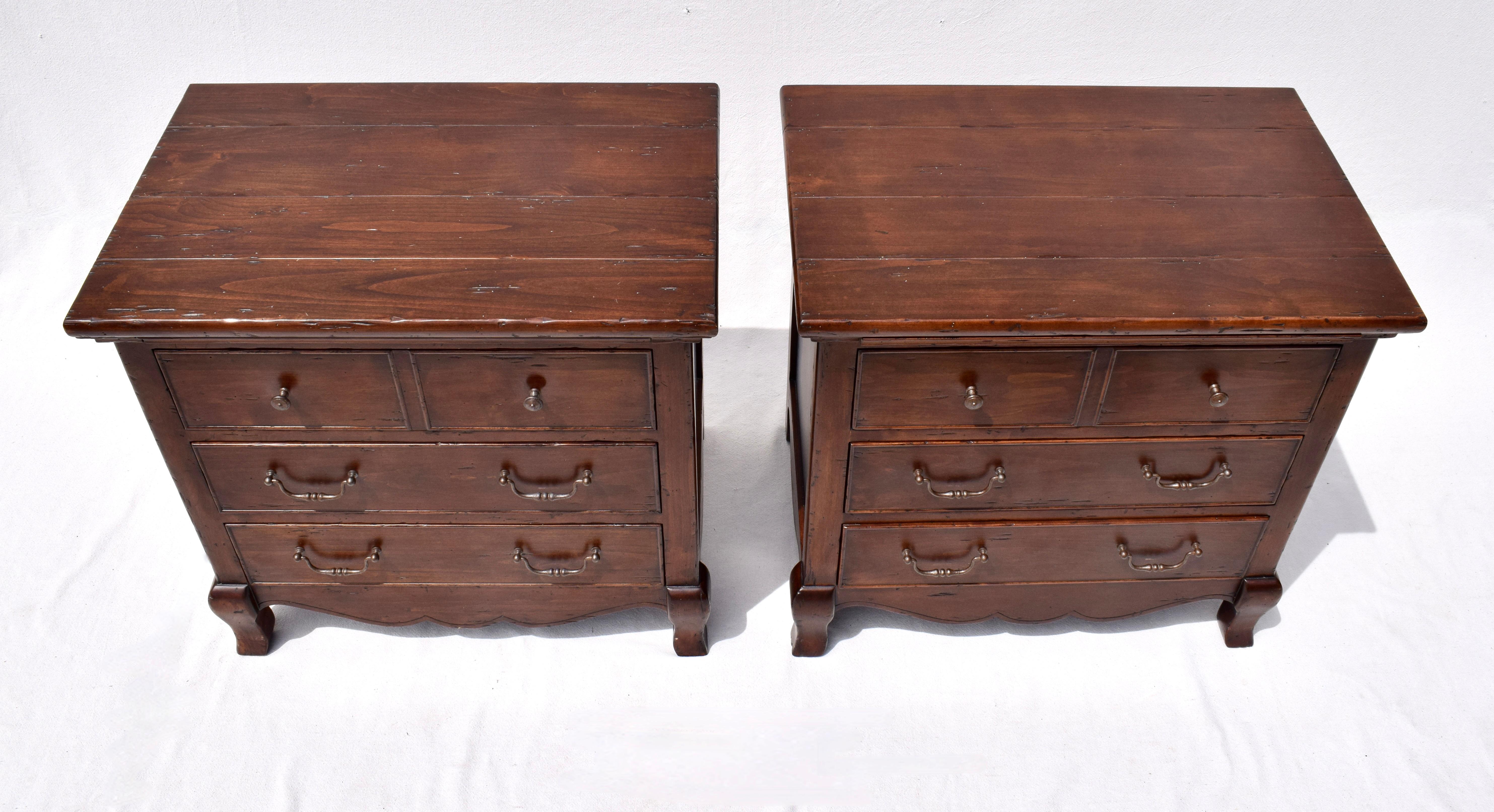 A pair of Fremarc Designs Chateau nightstands with pull-out shelf in rarely if ever used condition. Transitional in style with subtle French Country design elements.