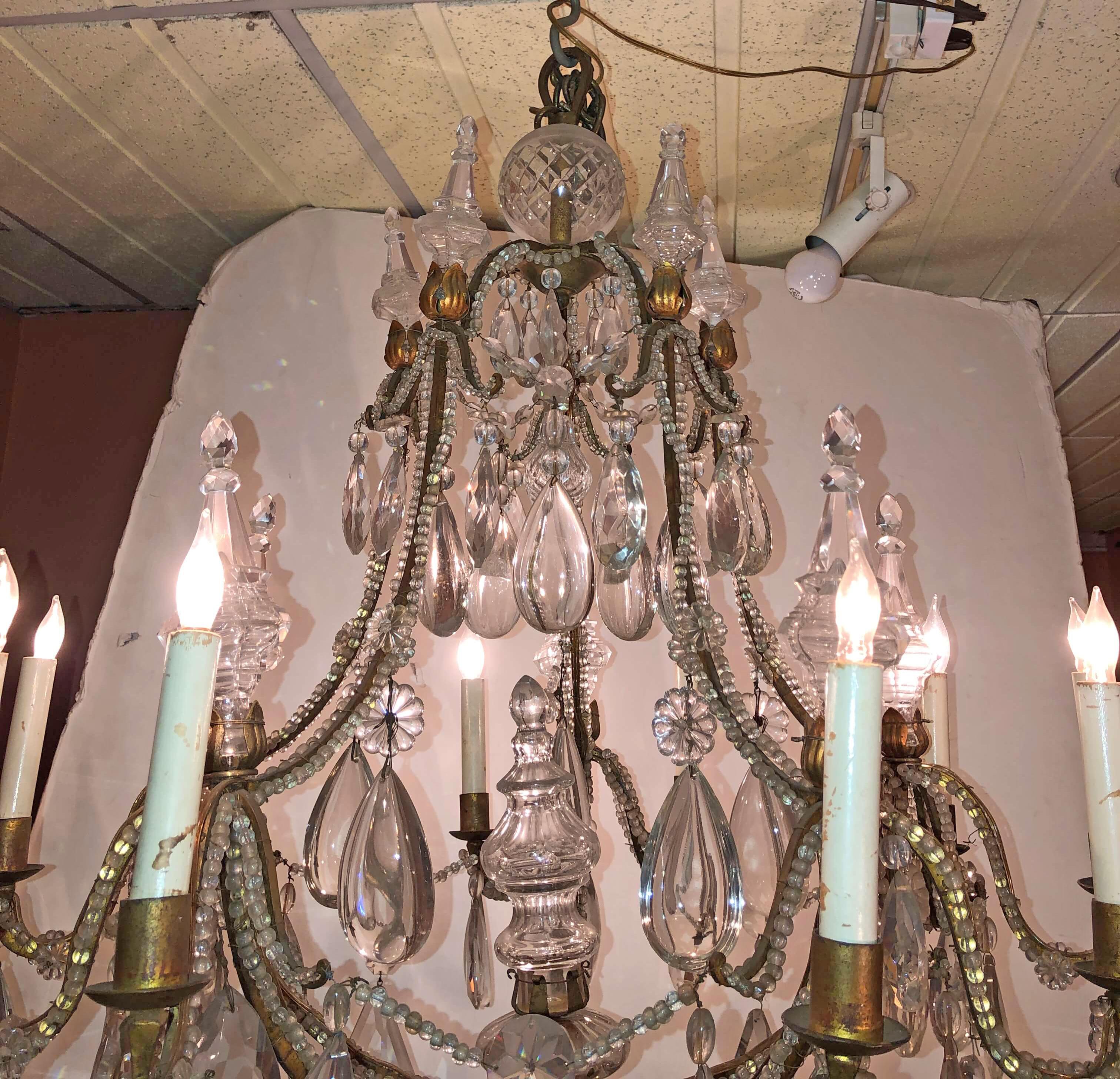 A fine French transitional iron, beaded and crystal 10-light chandelier.