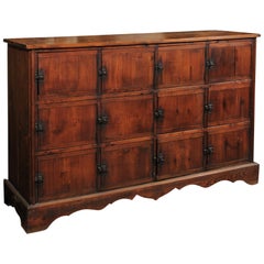 French 12-Door Rustic Cabinet with Warm Patina and Bracketed Plinth, circa 1920